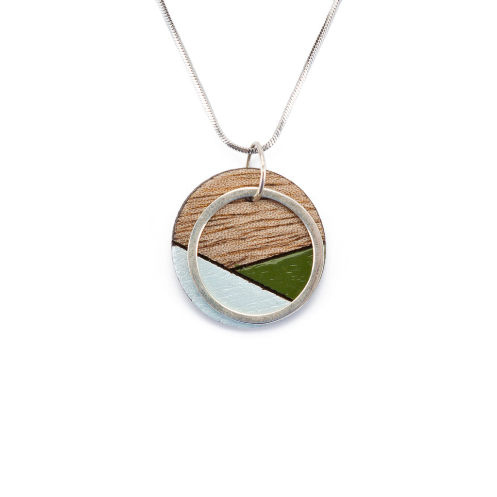 Conture Recycled Wood Silver Necklace showcasing vibrant colors and unique handcrafted design, featuring a silver titanium chain and brass ring.