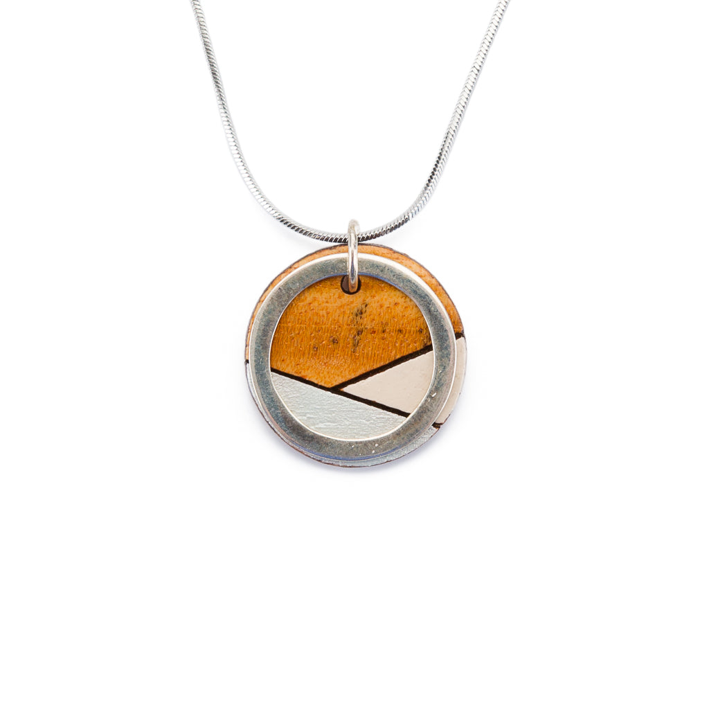 Conture Recycled Wood Silver Necklace showcasing vibrant colors and unique handcrafted design, featuring a silver titanium chain and brass ring.