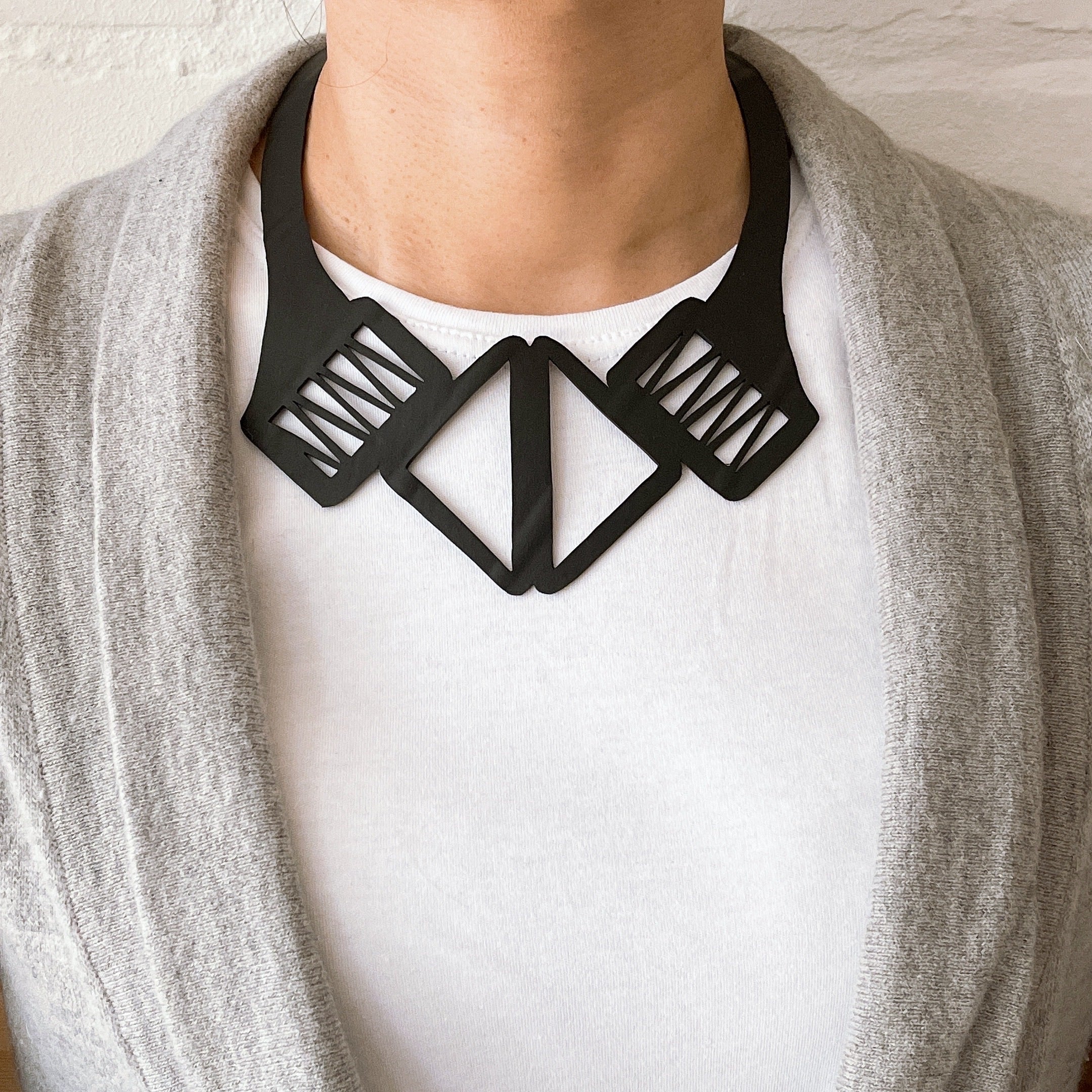 Copenhagen Inner Tube Necklace made from recycled rubber, showcasing a minimalist design with clean lines and a durable wraparound cord.