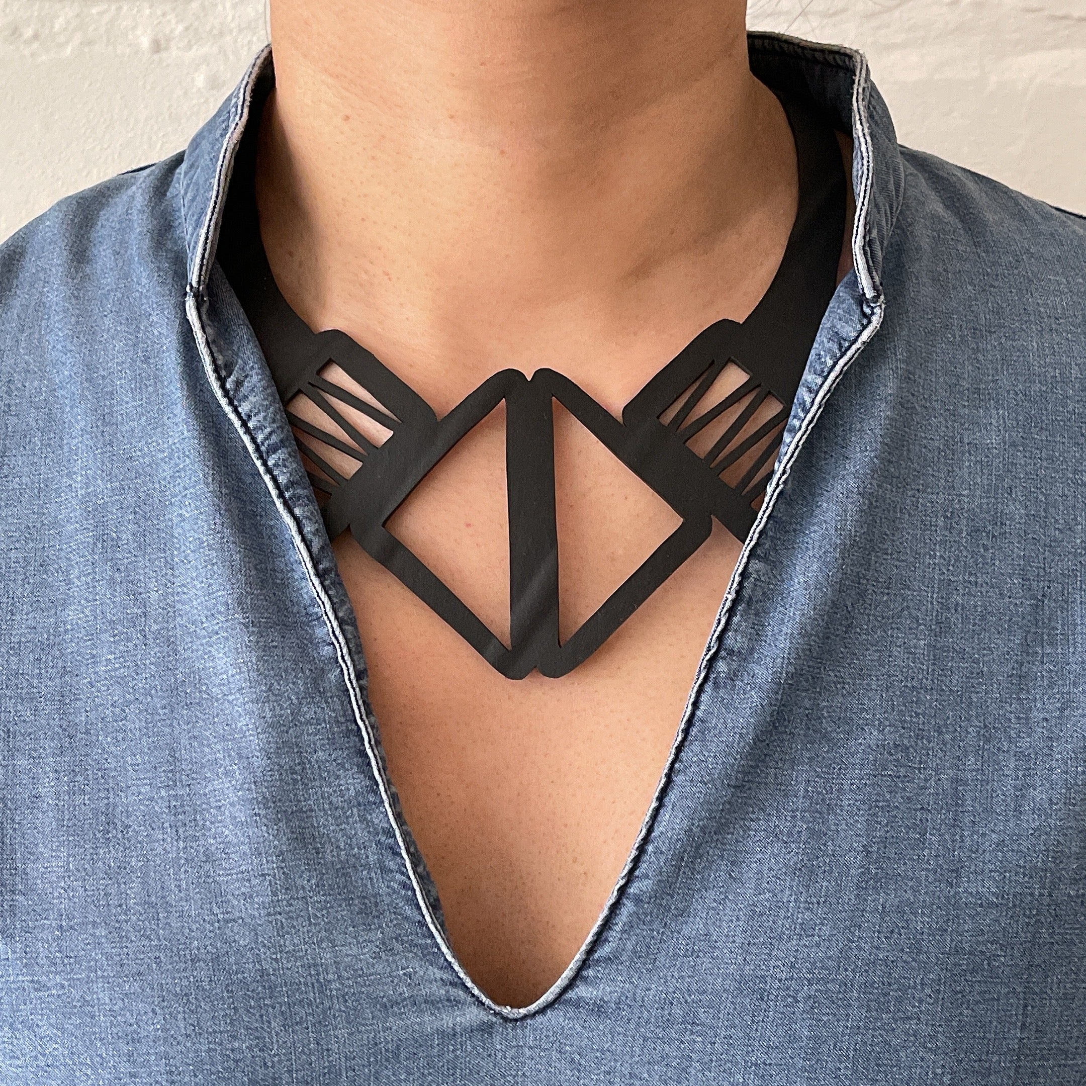 Copenhagen Inner Tube Necklace made from recycled rubber, showcasing a minimalist design with clean lines and a durable wraparound cord.