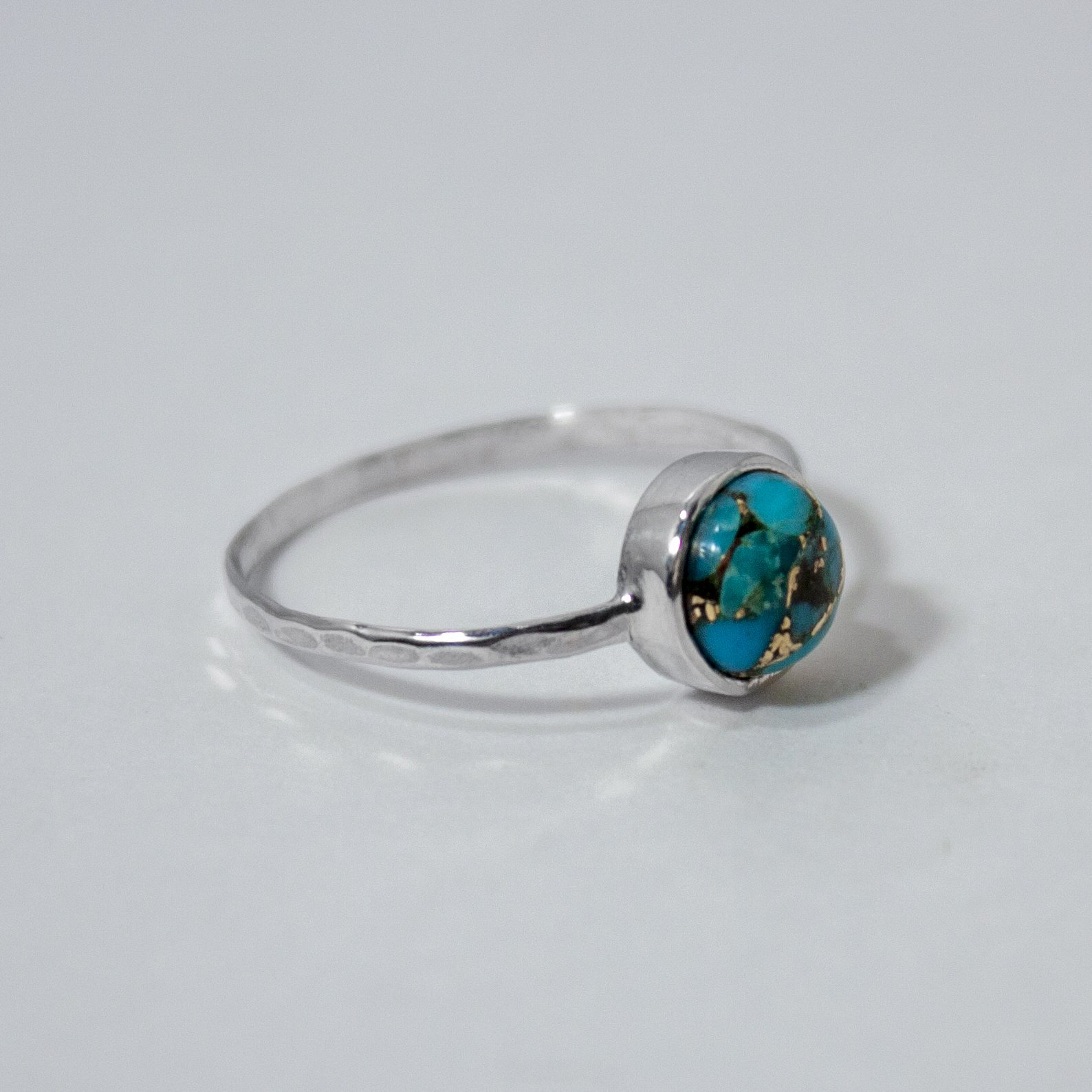 Copper Turquoise Bezel Sterling Silver Ring featuring a 6mm turquoise stone set in a hammered sterling silver band.