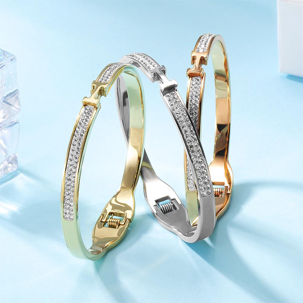 Thin H-Shaped CZ Bangle made of surgical stainless steel with gold plating, featuring sparkling cubic zirconia stones.