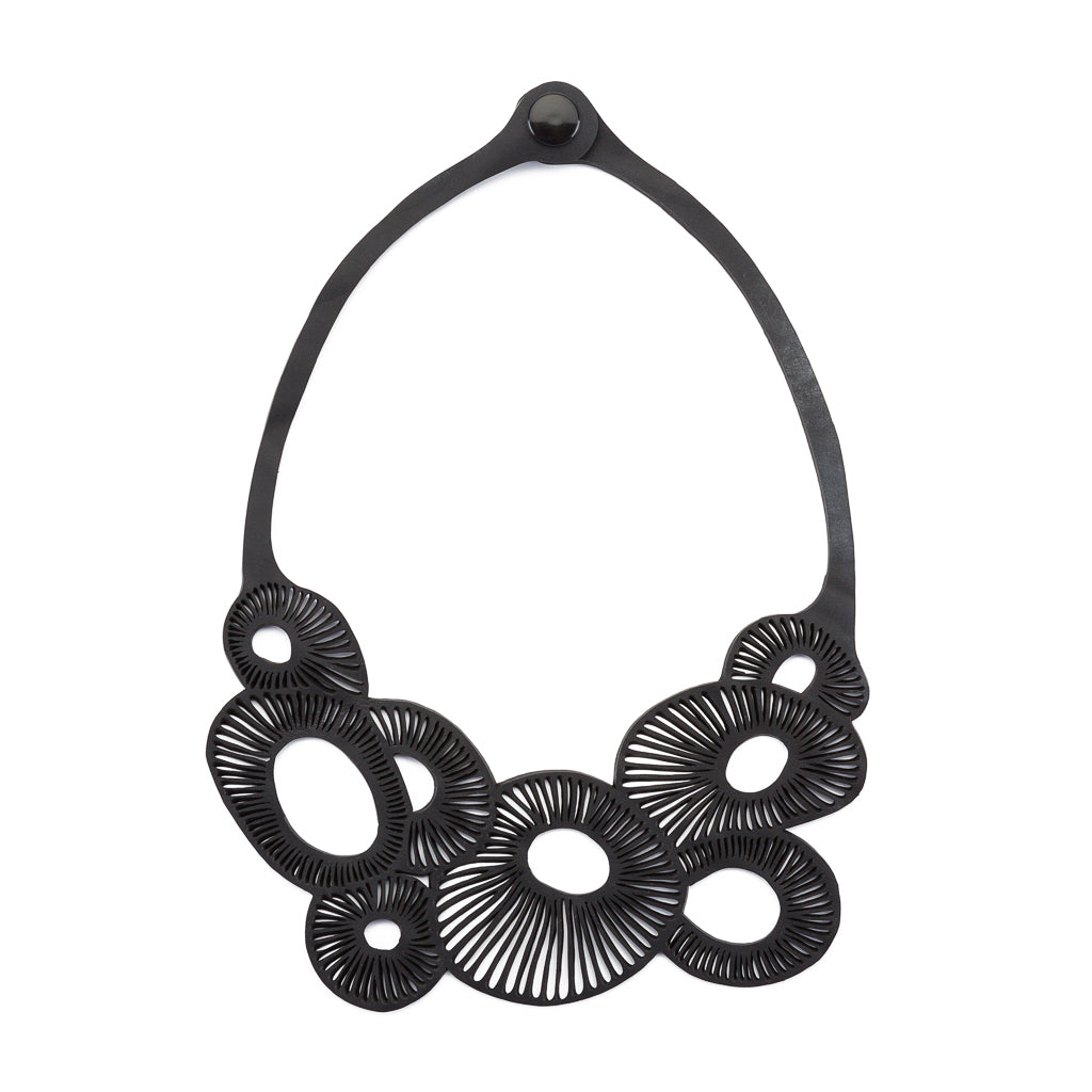 A stylish Coral Eco Friendly Rubber Necklace made from recycled materials, showcasing its unique design and craftsmanship.