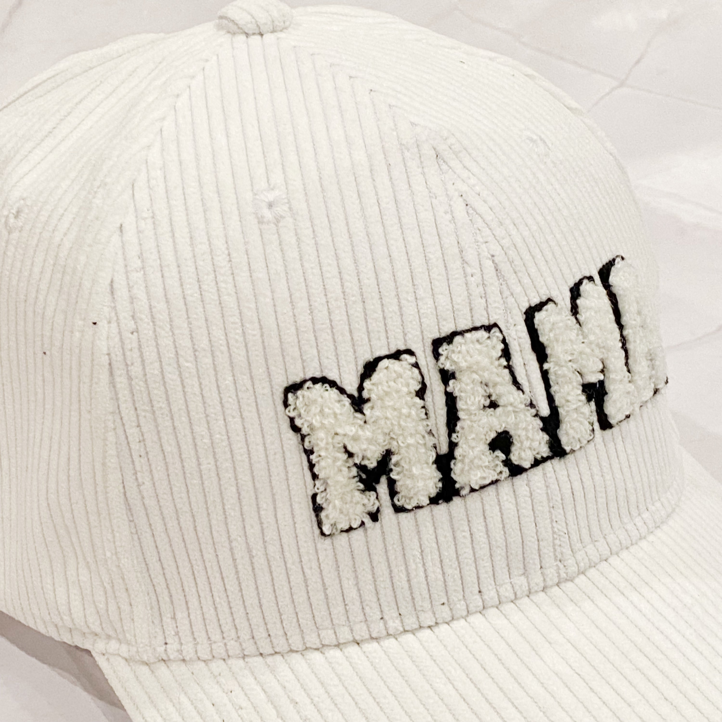 Corduroy Mama Ball Cap featuring fuzzy patch lettering and adjustable strap.