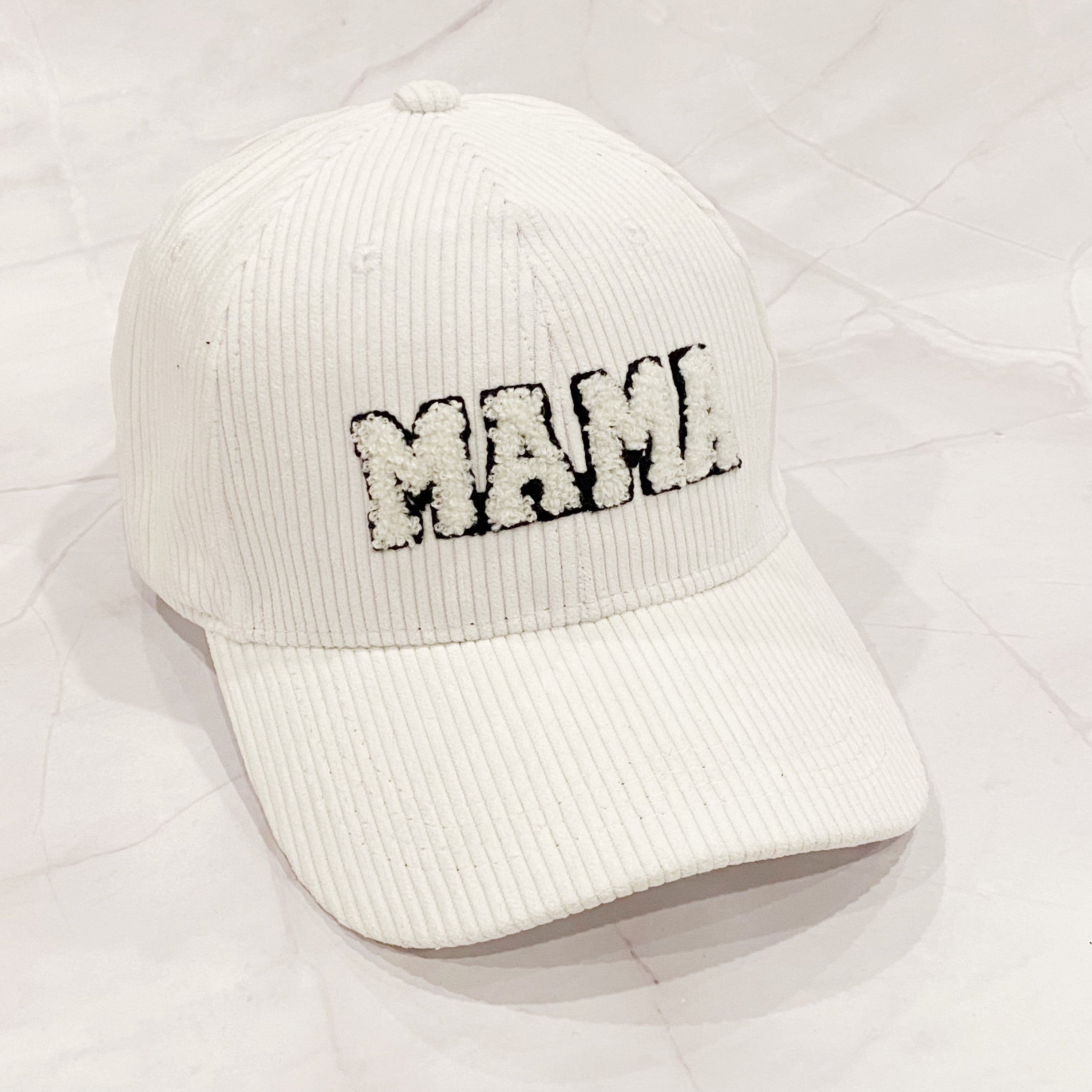 Corduroy Mama Ball Cap featuring fuzzy patch lettering and adjustable strap.