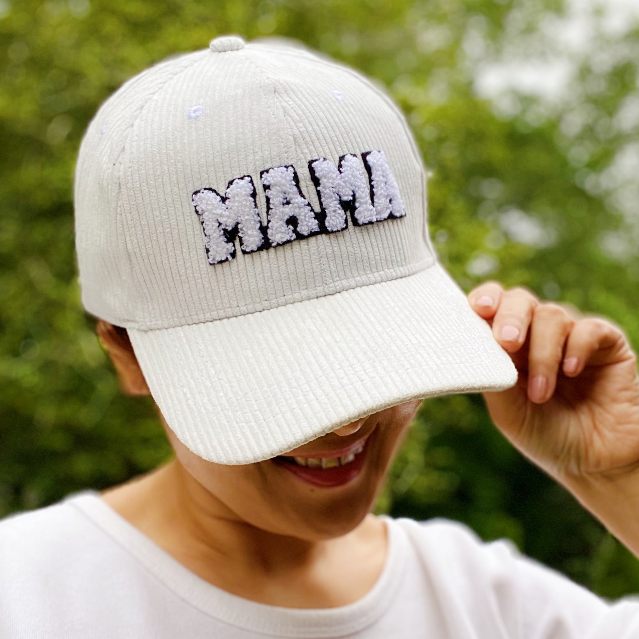 Corduroy Mama Ball Cap featuring fuzzy patch lettering and adjustable strap.