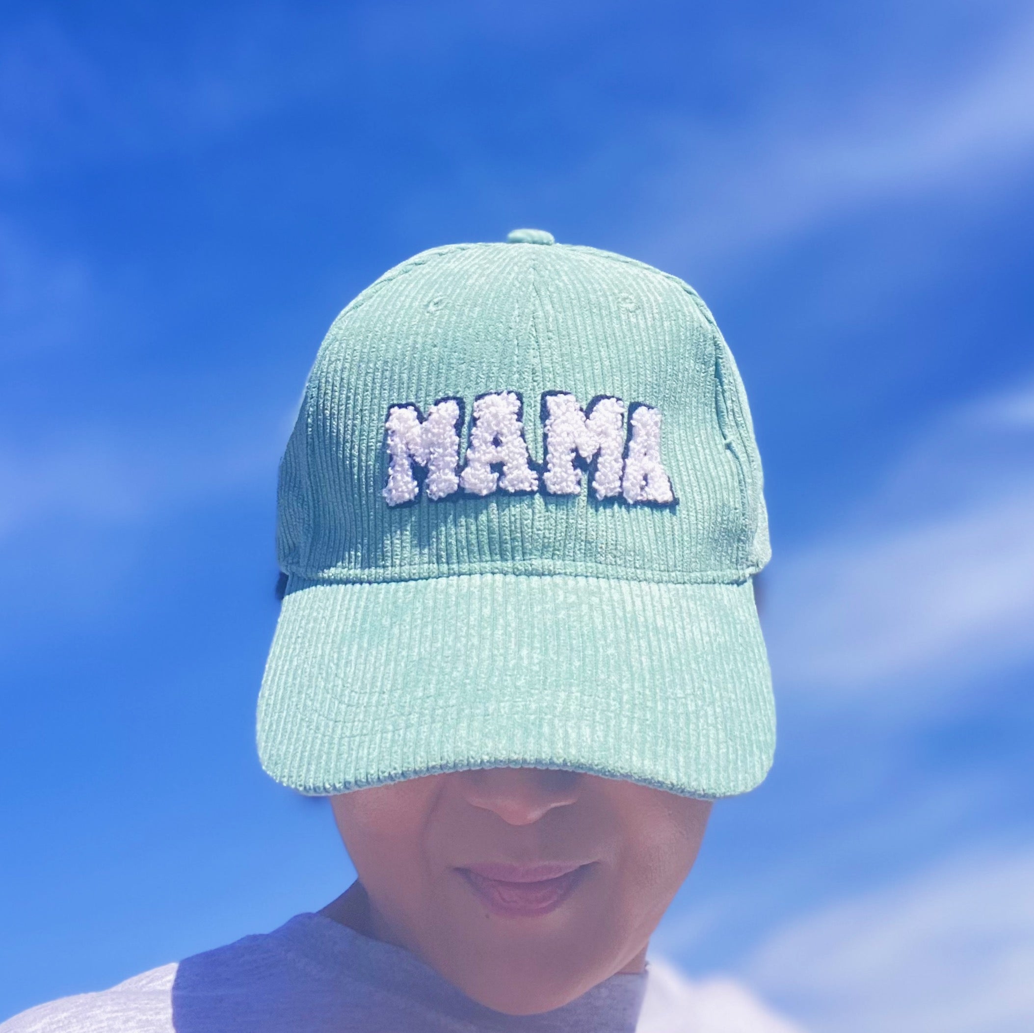 Corduroy Mama Ball Cap featuring fuzzy patch lettering and adjustable strap.