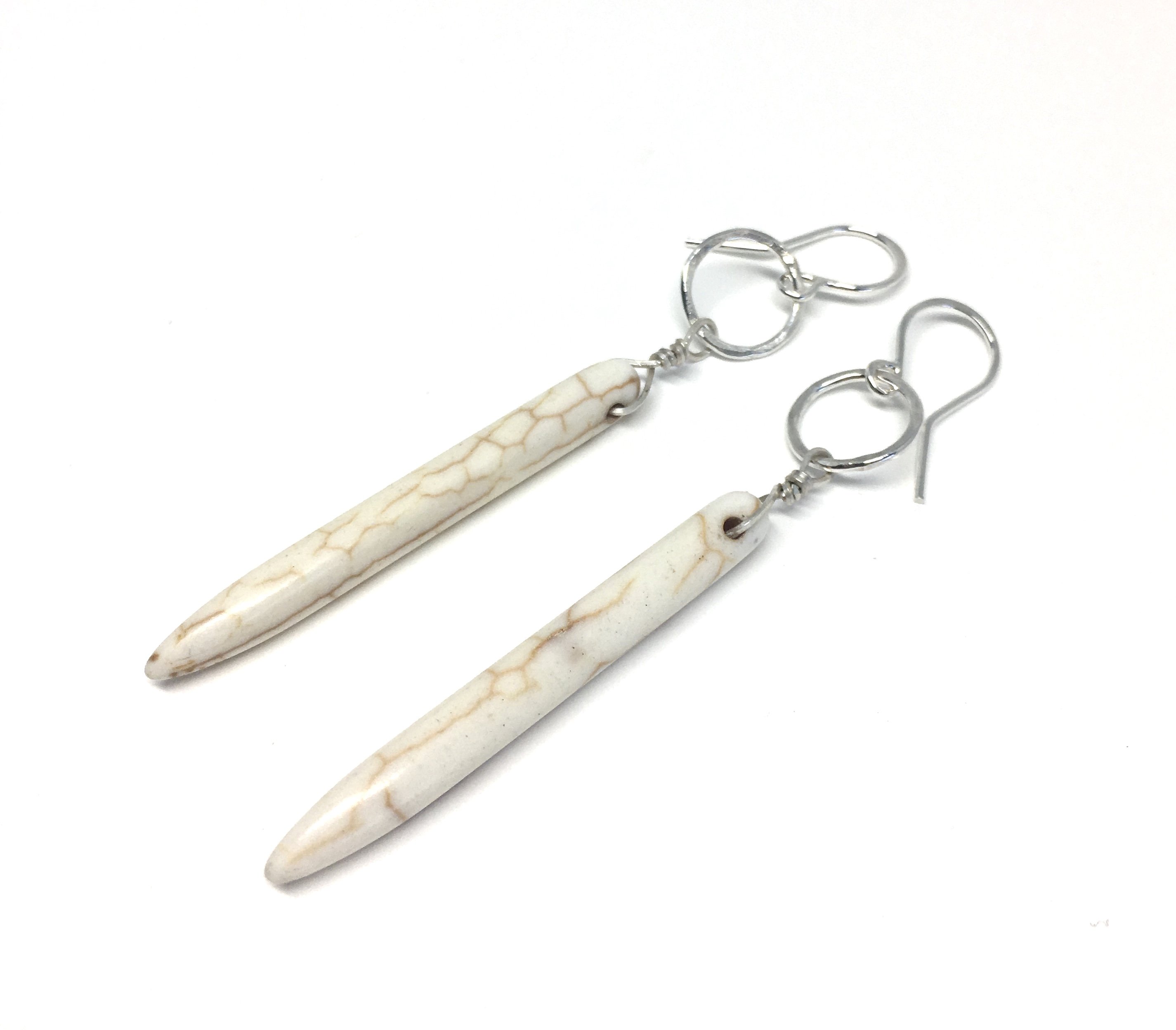 Elegant cream howlite drop earrings with rustic hammered circles, showcasing Southwestern style.