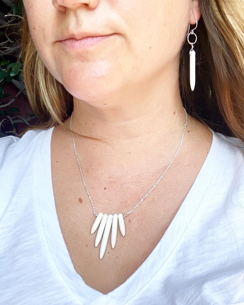 Elegant cream howlite drop earrings with rustic hammered circles, showcasing Southwestern style.