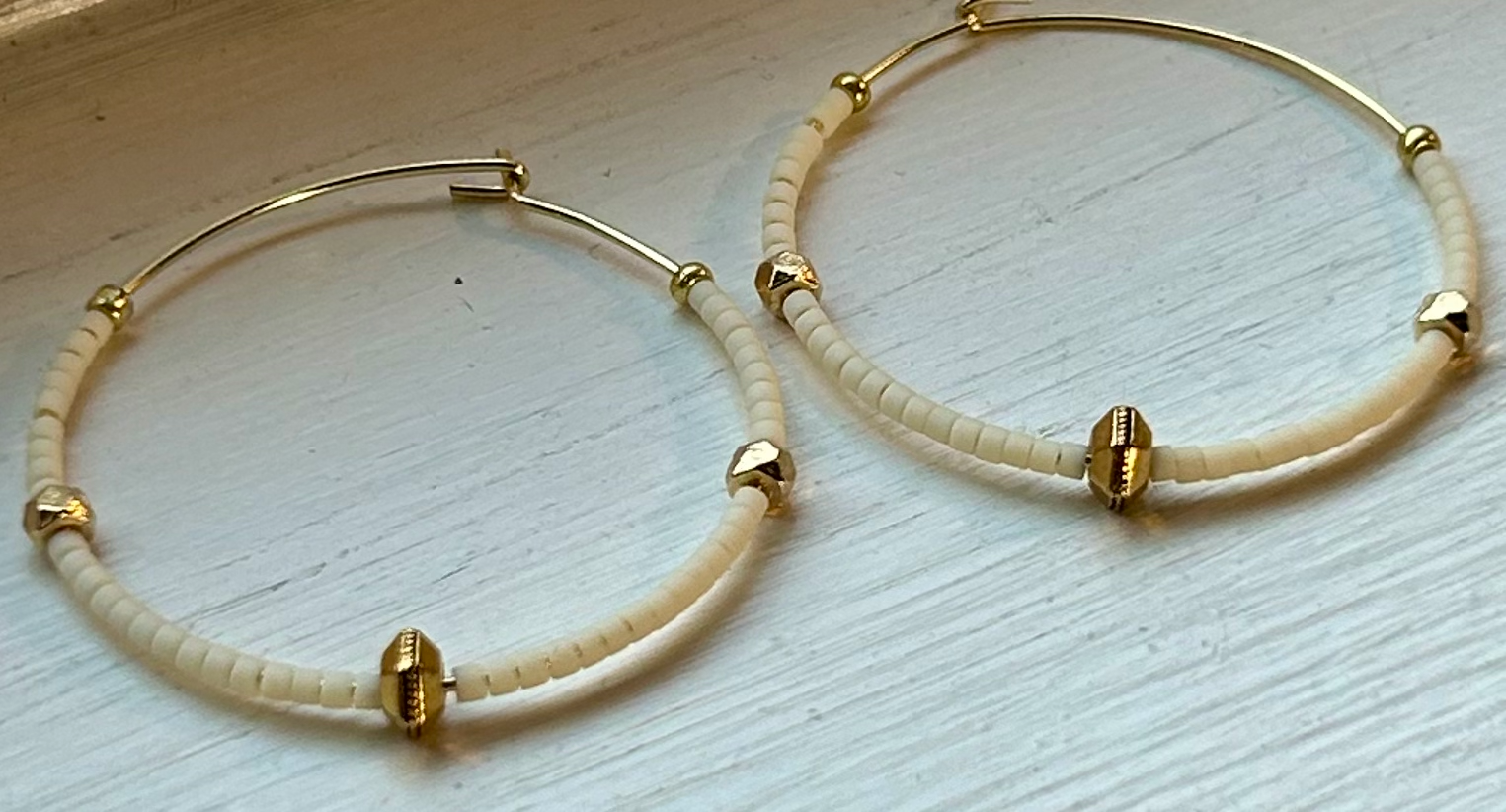 Creamy White & Bold Gold Beaded Hoops featuring gold-colored hoops and Czech glass seed beads, perfect for bohemian style.