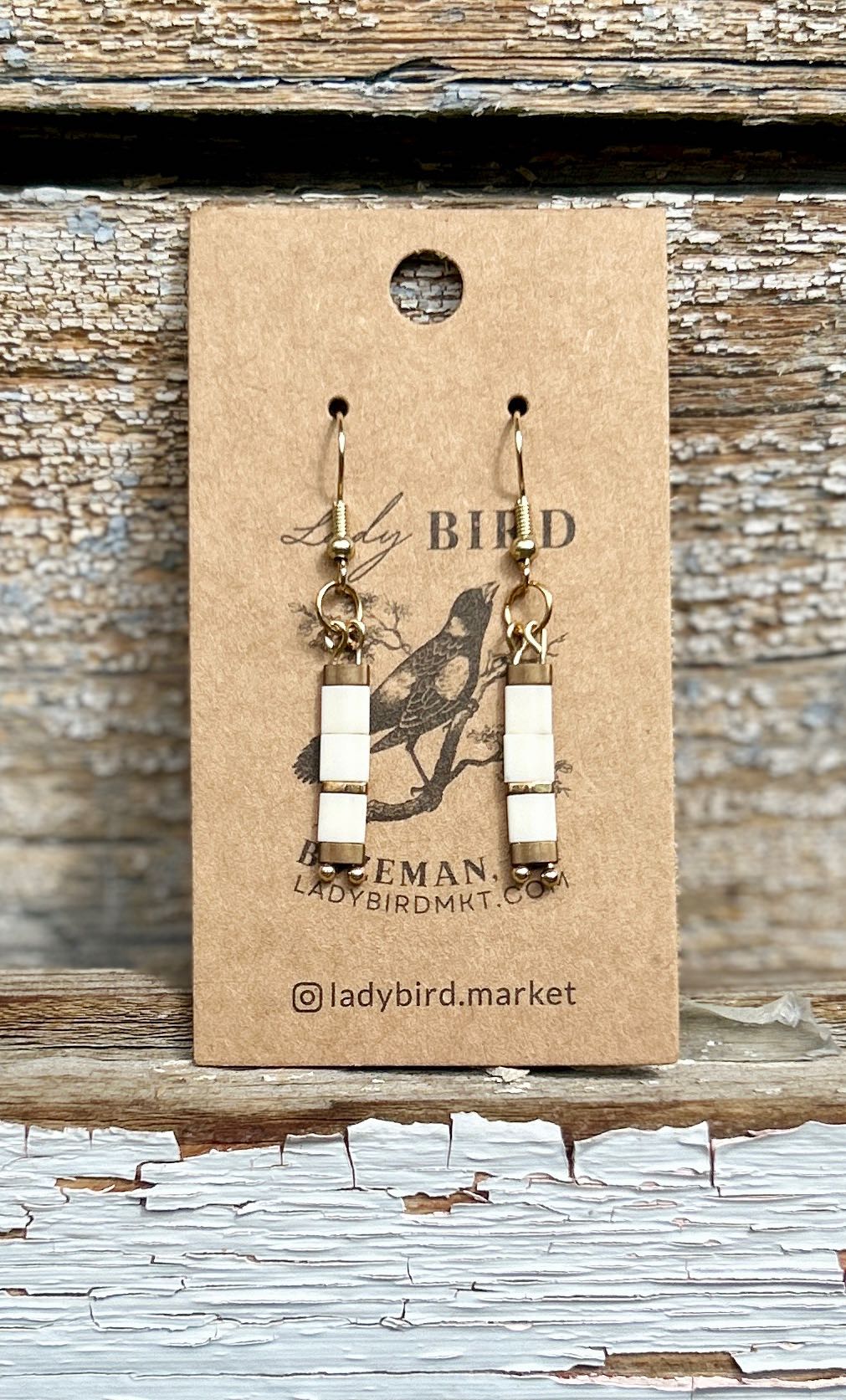 Elegant Creamy White Tila Bead Earrings with Gold and Silver accents, showcasing a bohemian style.