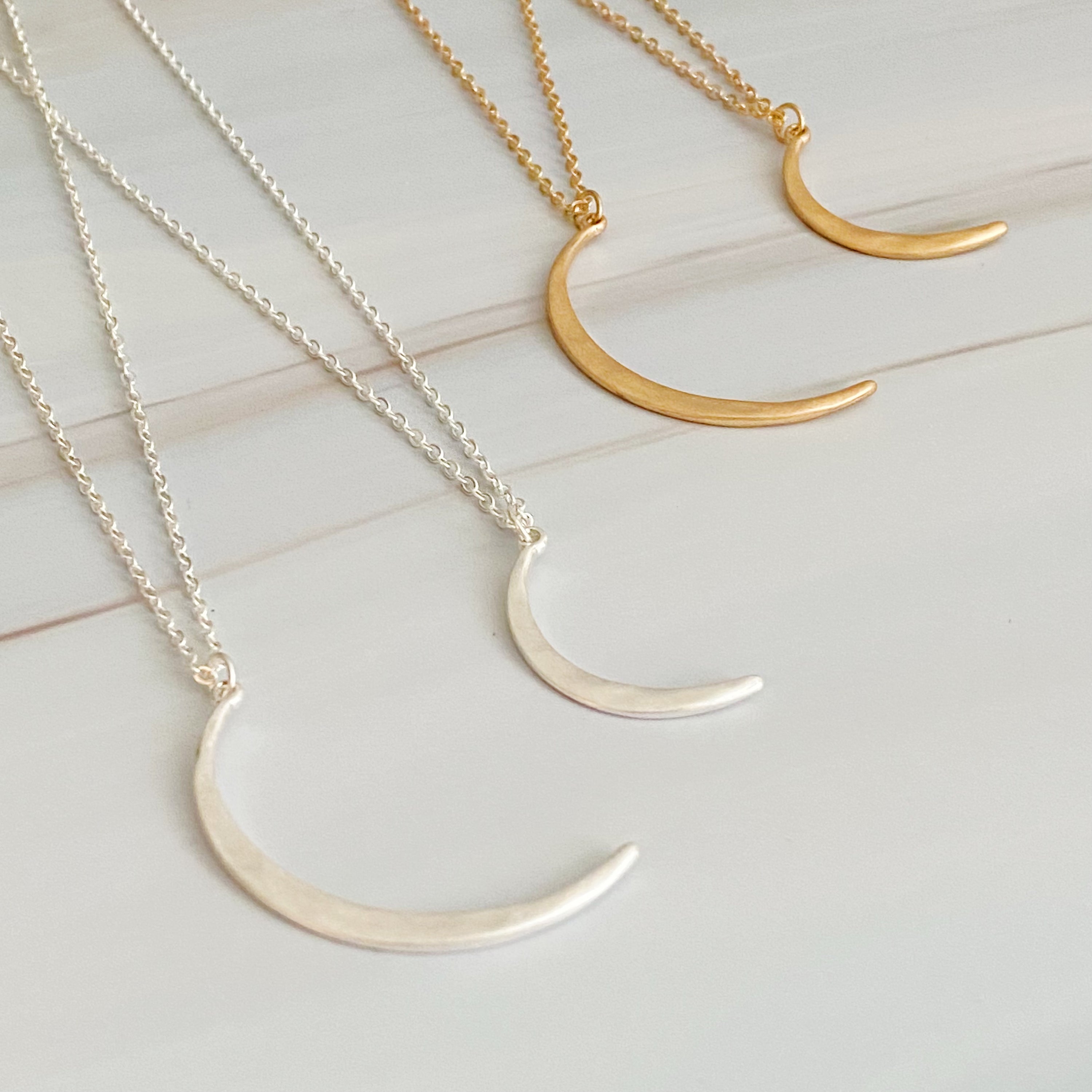 Crescent Duo Necklace Set of 2 featuring two crescent pendants in different sizes on adjustable chains.