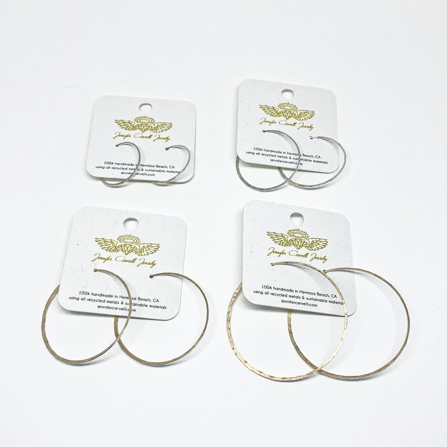 Elegant crescent moon hoop earrings in various sizes and finishes, showcasing a hammered texture and organic curves.