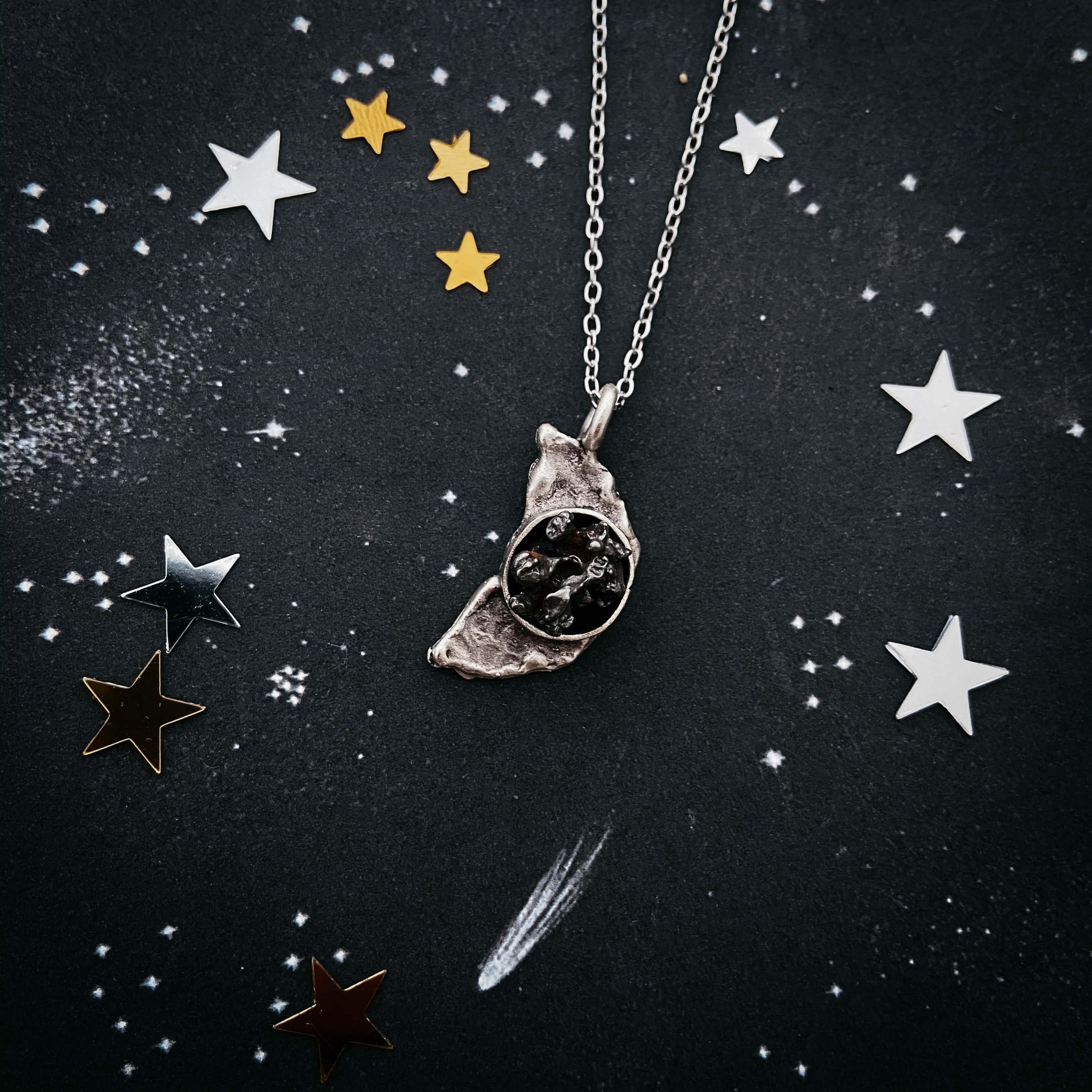 Crescent Moon Necklace featuring authentic Campo del Cielo meteorite with a hammered finish, elegantly displayed on a soft background.