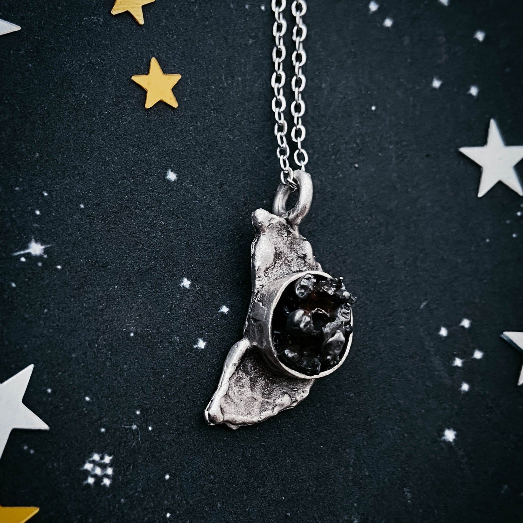 Crescent Moon Necklace featuring authentic Campo del Cielo meteorite with a hammered finish, elegantly displayed on a soft background.