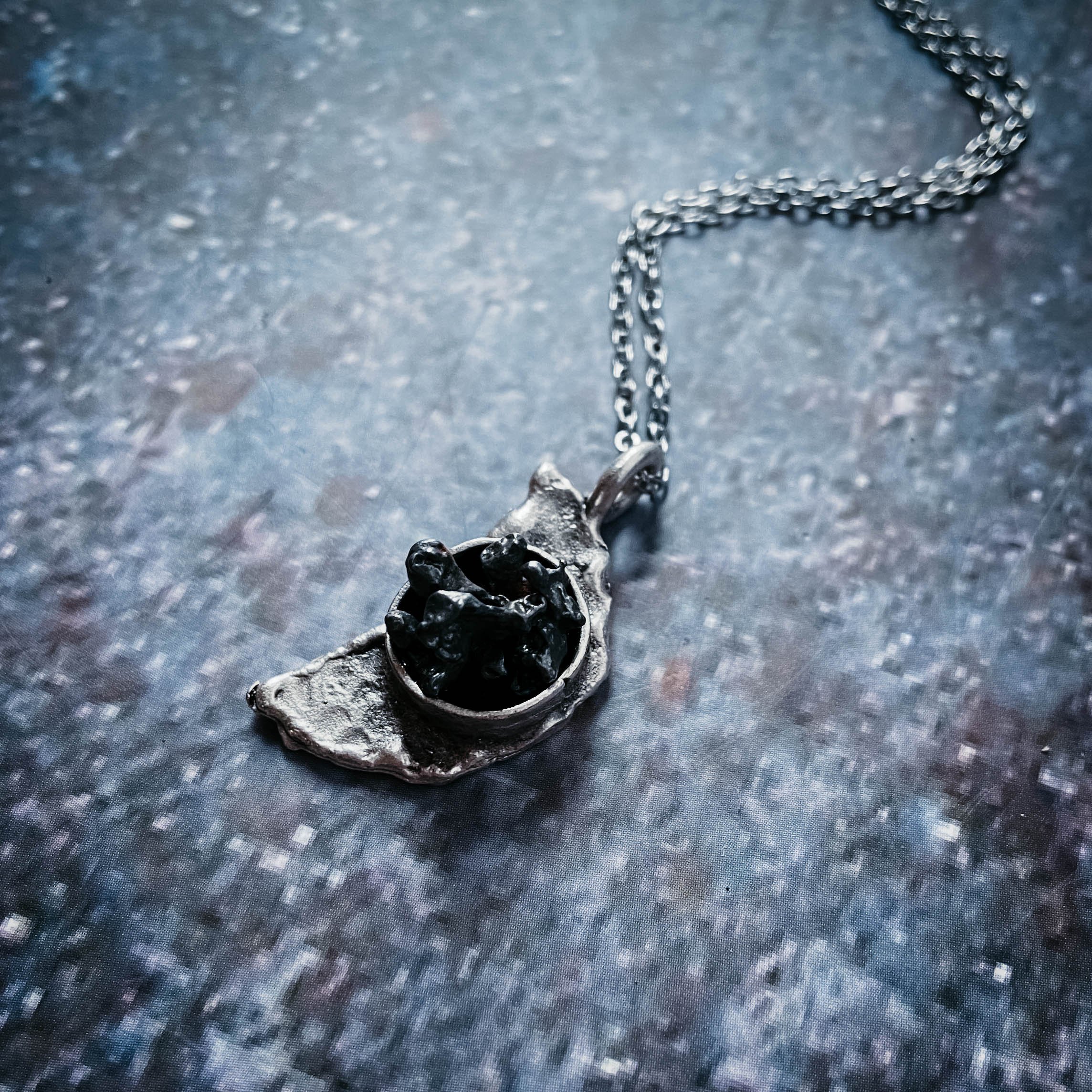 Crescent Moon Necklace featuring authentic Campo del Cielo meteorite with a hammered finish, elegantly displayed on a soft background.