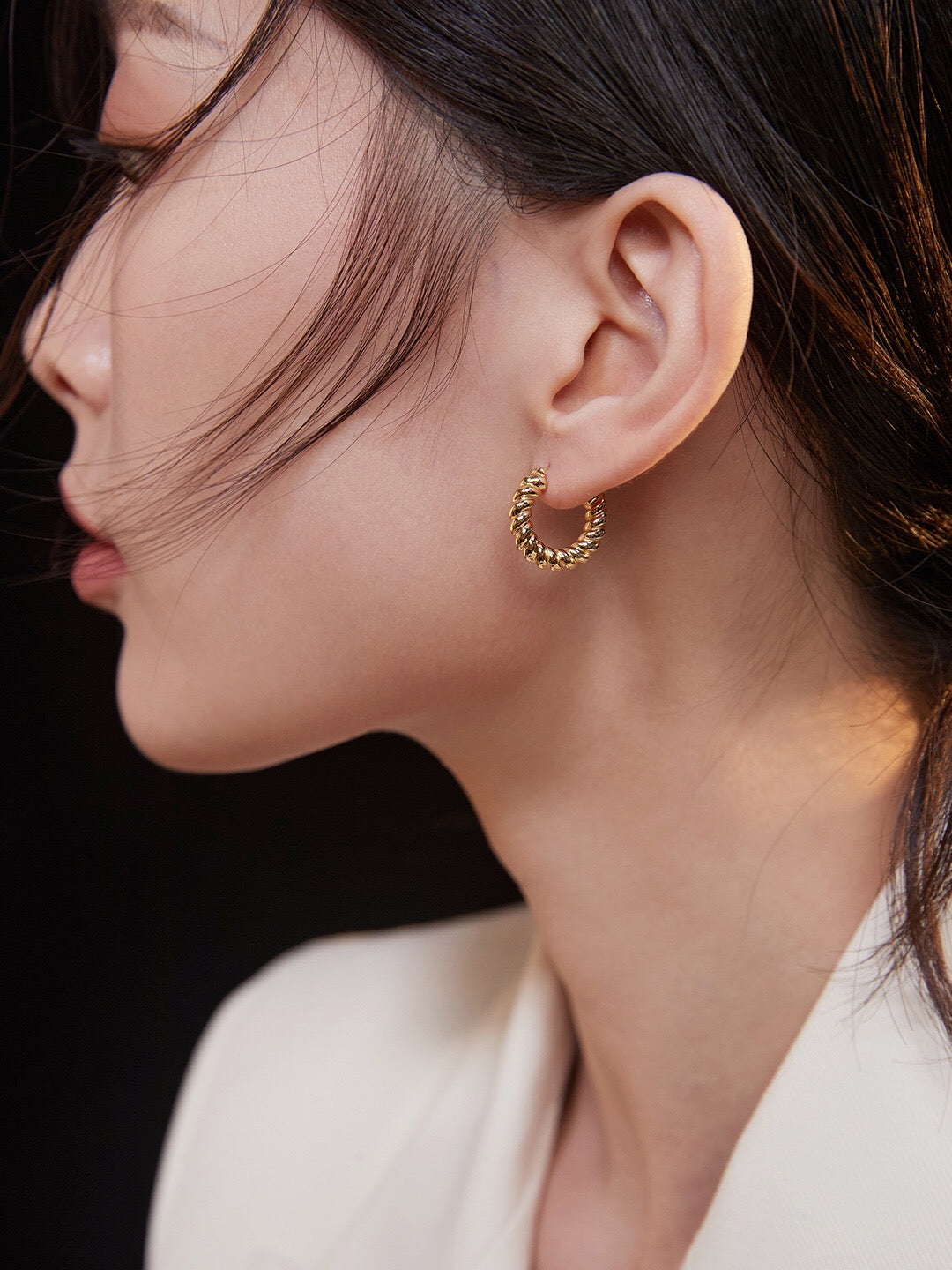 A pair of elegant Croissant Hoop Earrings made from gold vermeil, showcasing their unique shape and shine.