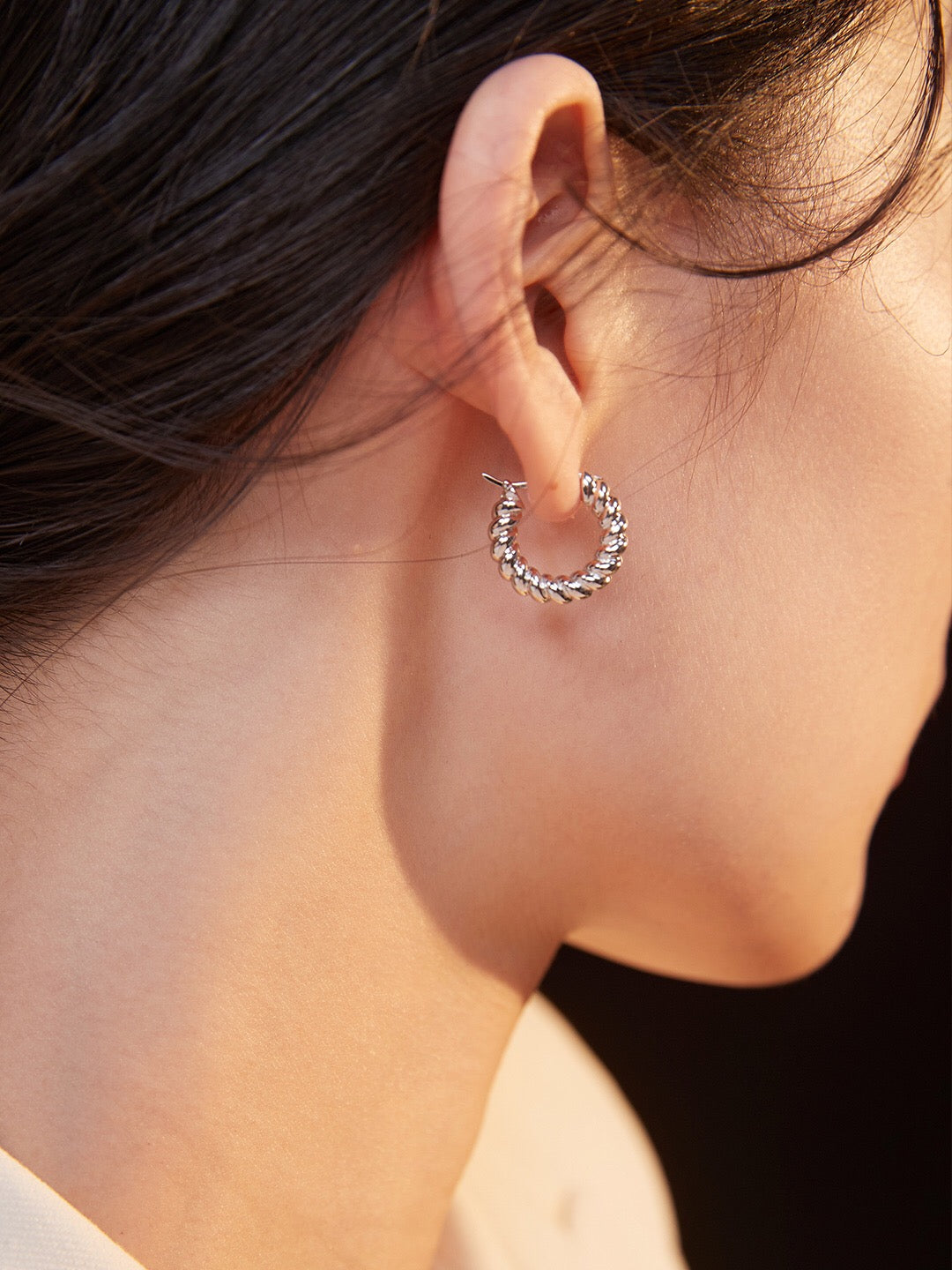 A pair of elegant Croissant Hoop Earrings made from gold vermeil, showcasing their unique shape and shine.