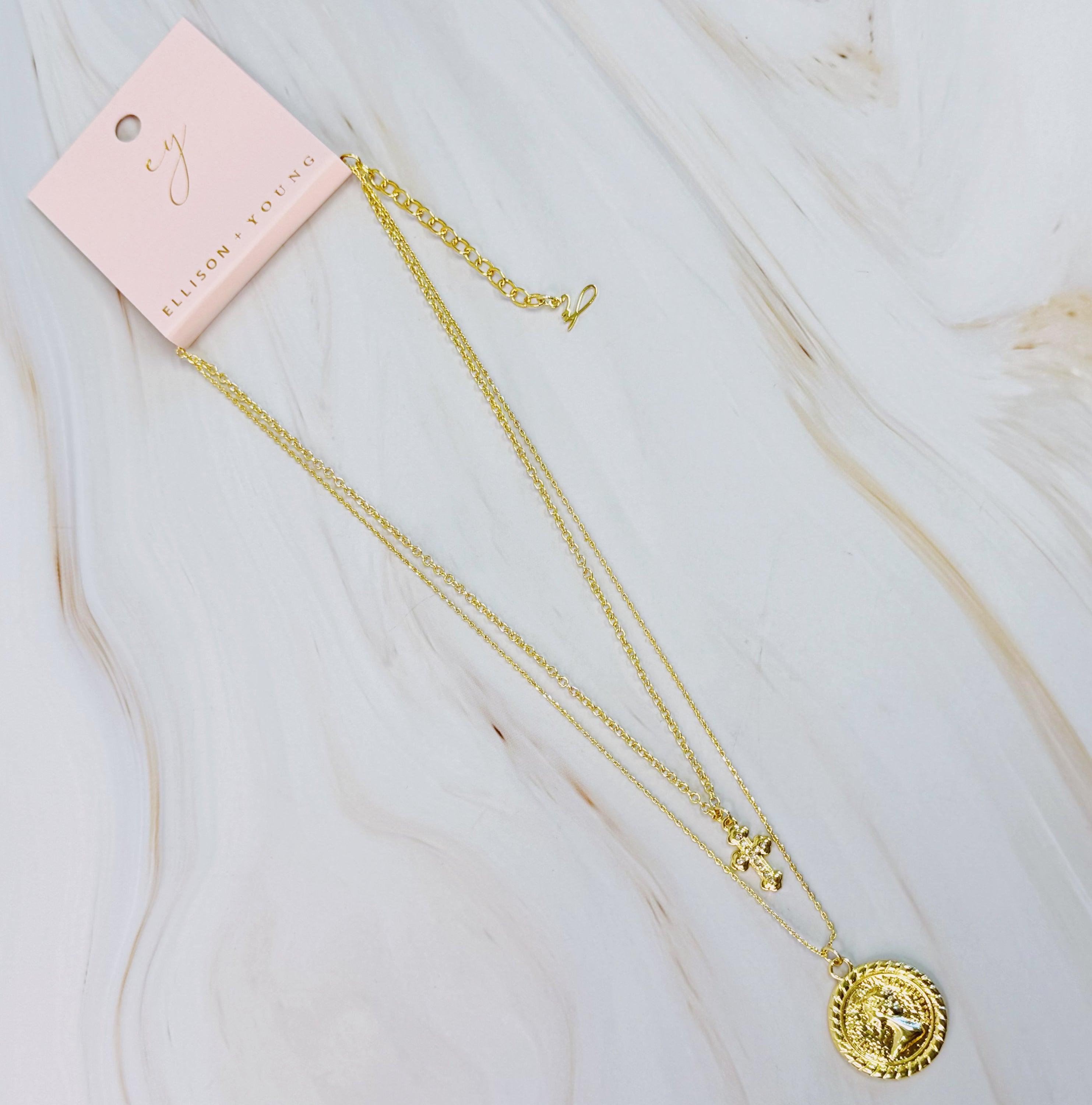 Cross and Coin Layered Necklace featuring a gold plated cross and classic coin design, elegantly layered for a stylish look.