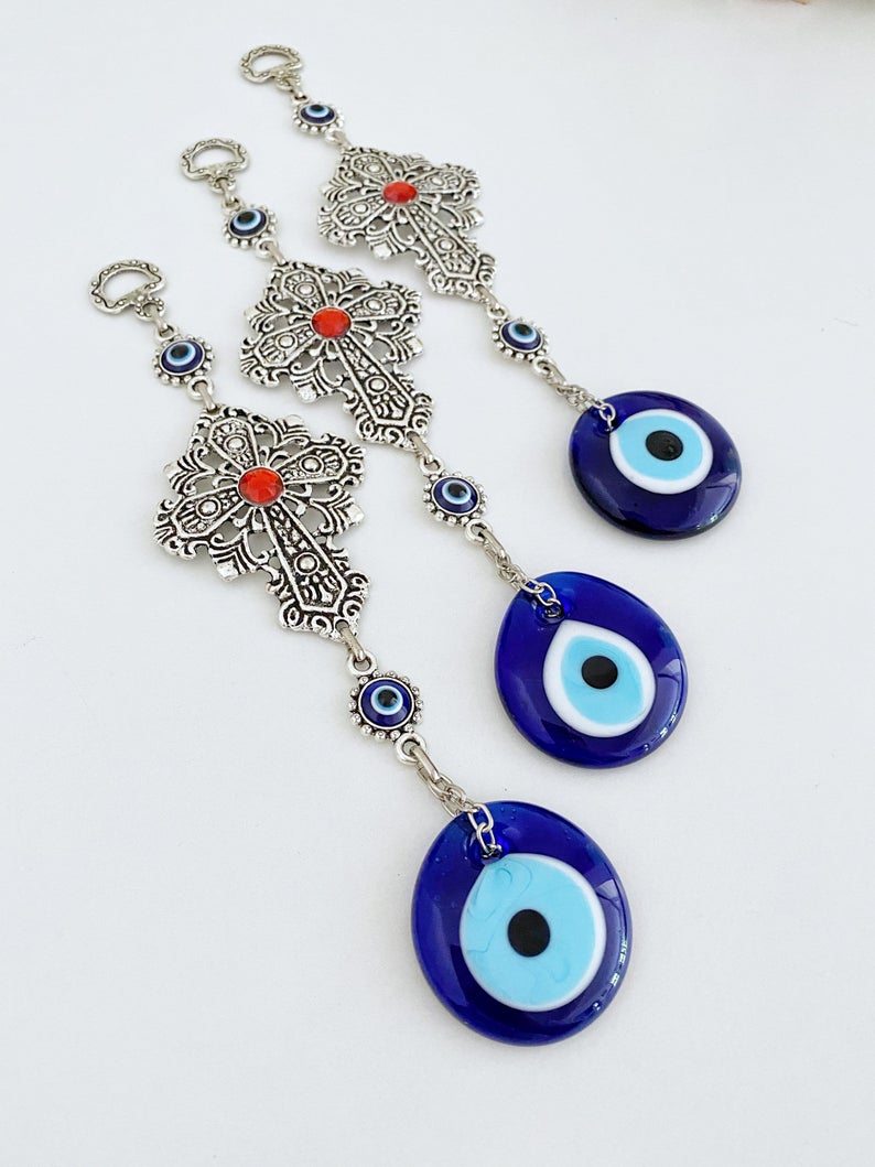 Cross Evil Eye Wall Hanging featuring a metal cross and evil eye ornament, perfect for rustic and religious home decor.