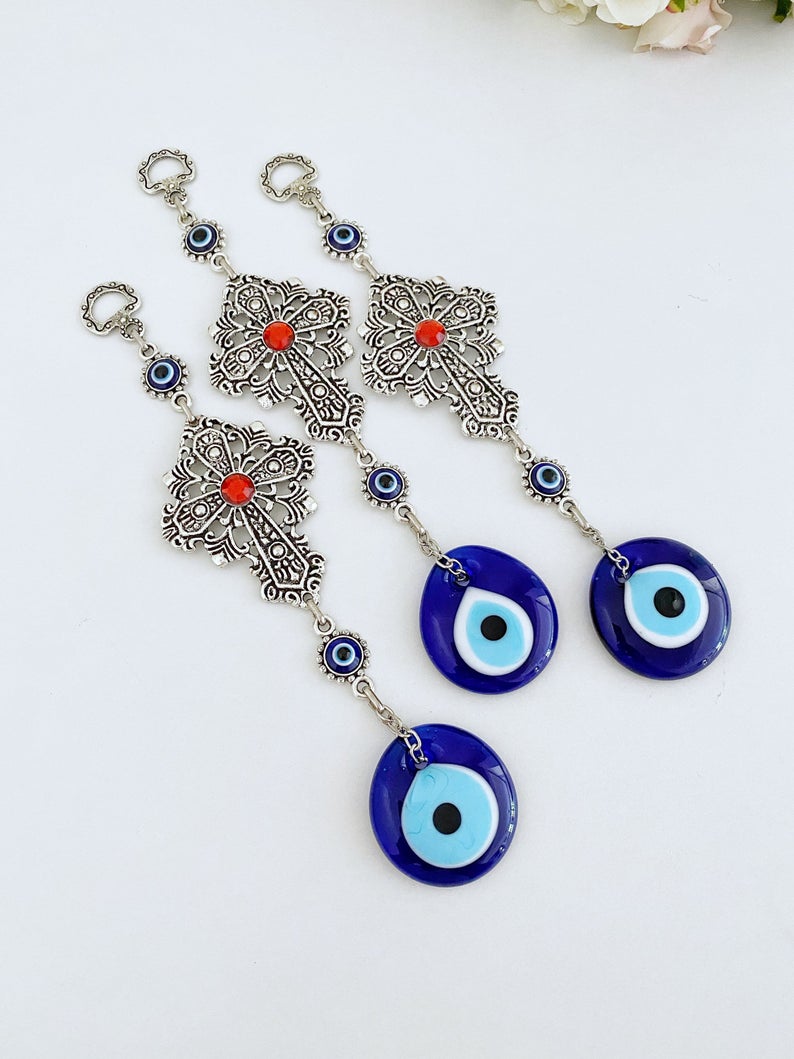 Cross Evil Eye Wall Hanging featuring a metal cross and evil eye ornament, perfect for rustic and religious home decor.