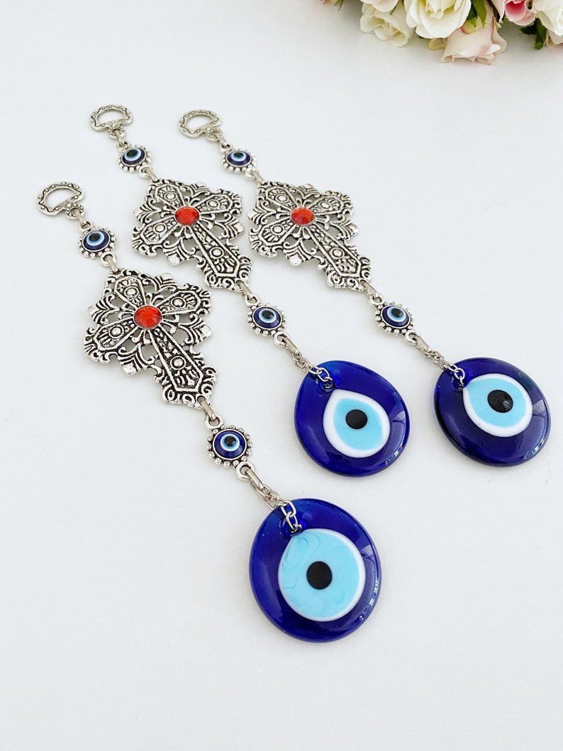 Cross Evil Eye Wall Hanging featuring a metal cross and evil eye ornament, perfect for rustic and religious home decor.