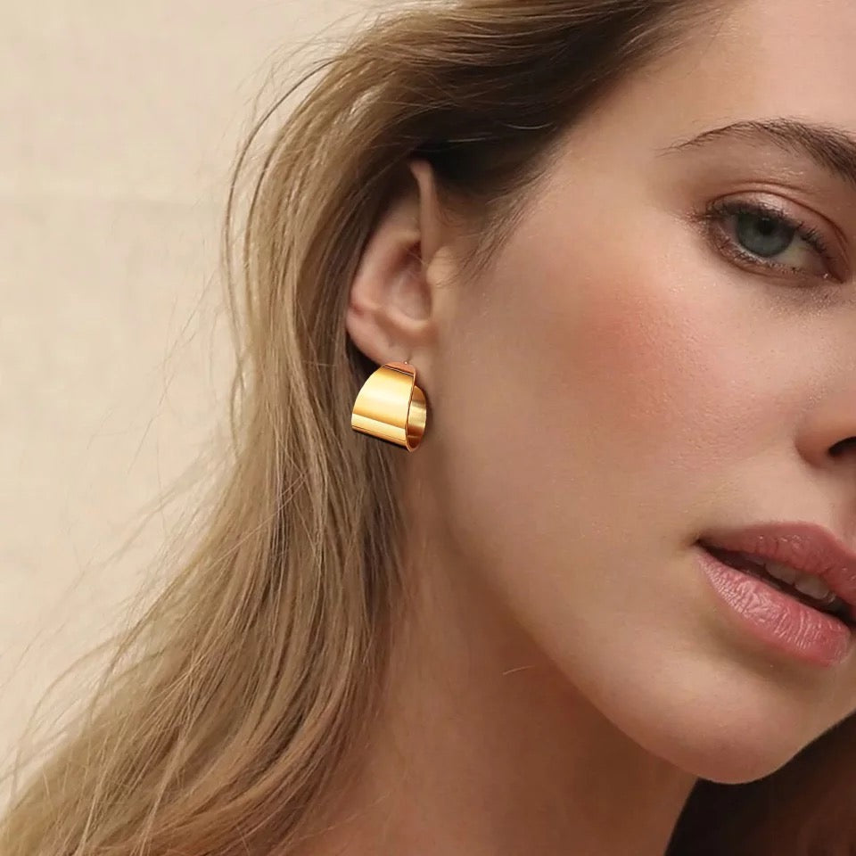 A pair of Crosby Hoops, 18k gold plated stainless steel earrings, showcasing a unique and elegant design.