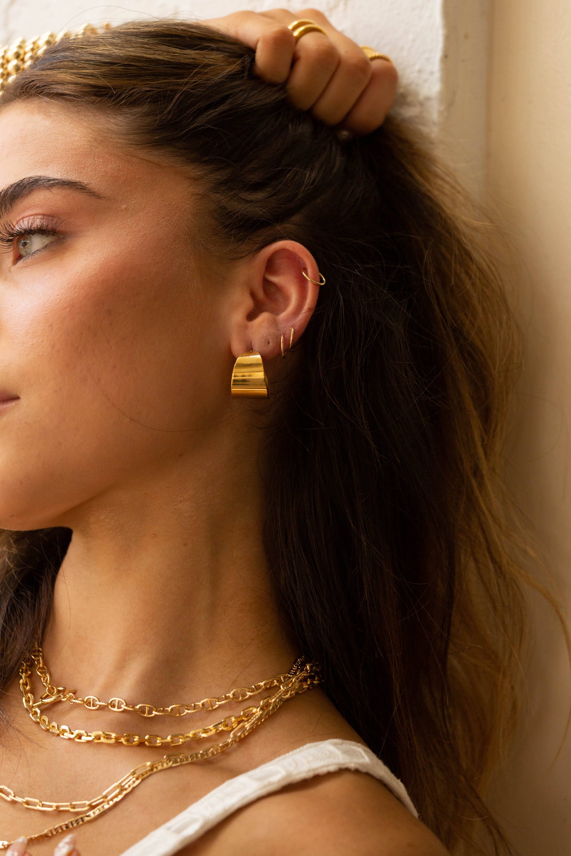 A pair of Crosby Hoops, 18k gold plated stainless steel earrings, showcasing a unique and elegant design.