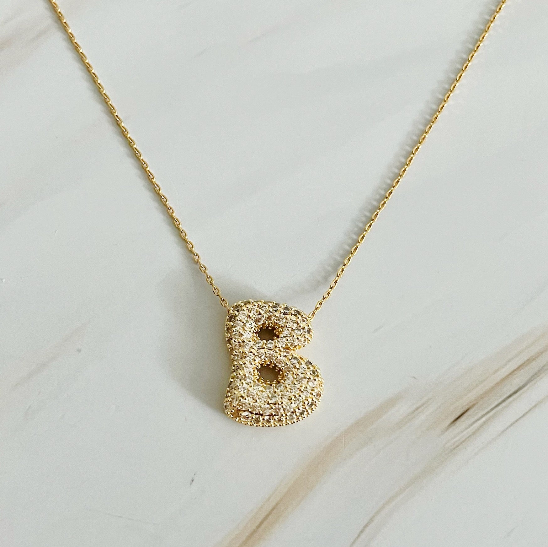 Elegant Crystal Bubble Initial Necklace in 18k gold plating with customizable charm.