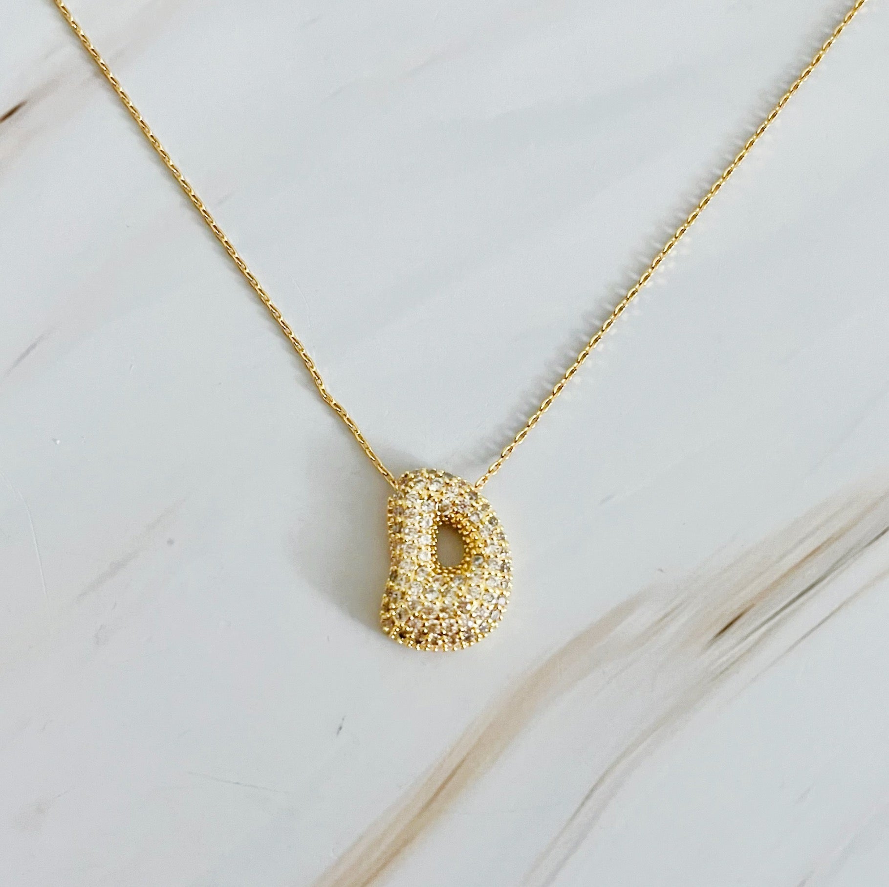 Elegant Crystal Bubble Initial Necklace in 18k gold plating with customizable charm.