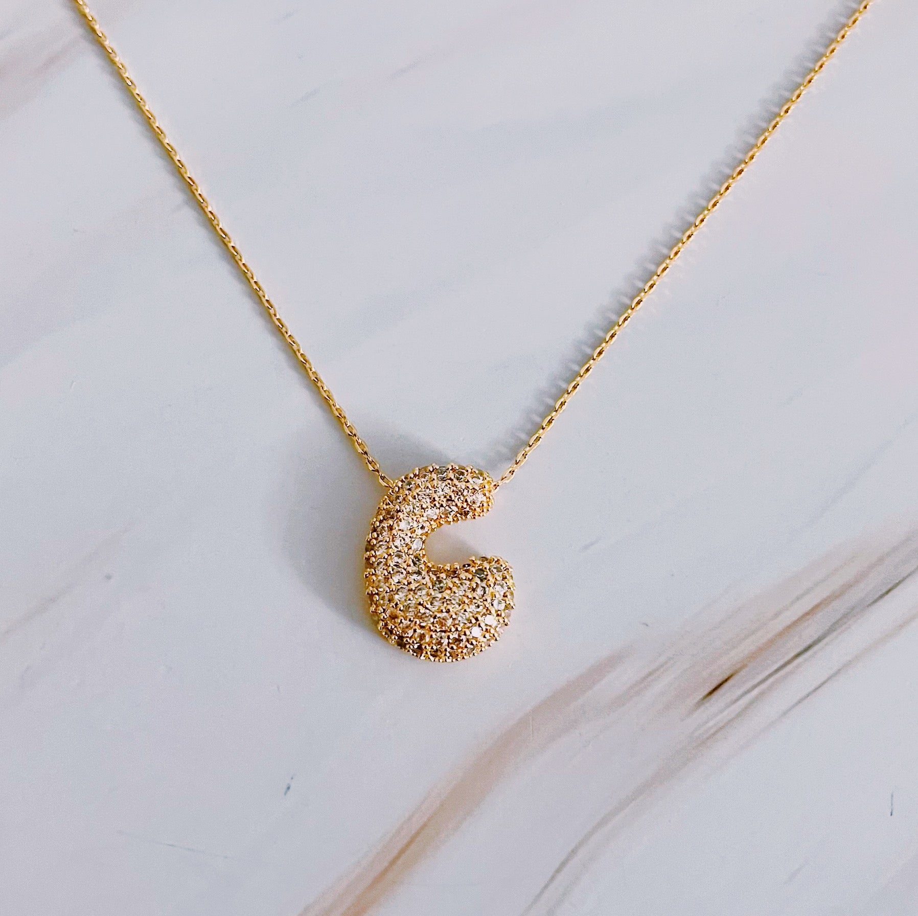 Elegant Crystal Bubble Initial Necklace in 18k gold plating with customizable charm.