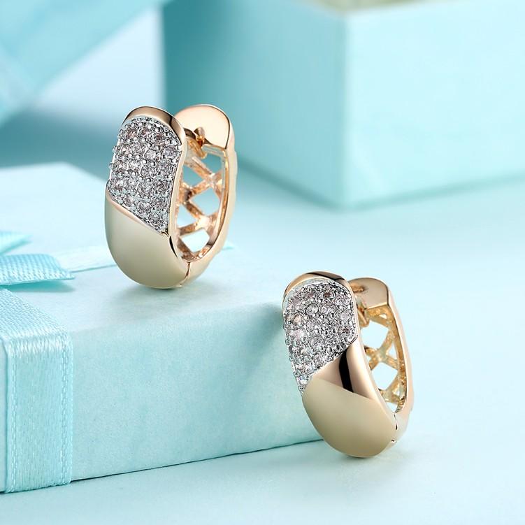 A pair of elegant Crystal Curved Layering Huggies Set in 18K Gold, showcasing their beautiful design and sparkling crystals.