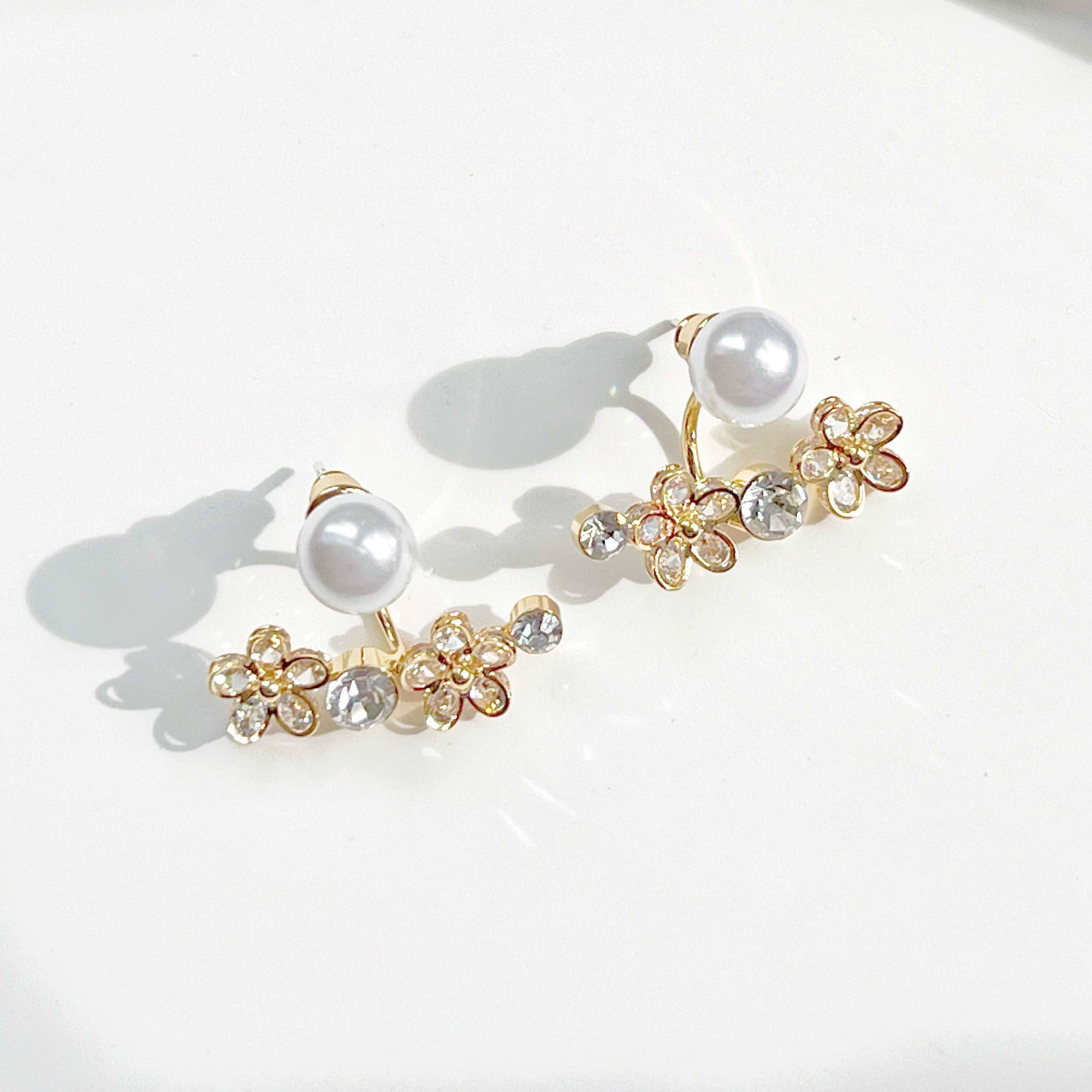 Elegant crystal flower and pearl ear jackets displayed in a gift box, showcasing their versatile design and quality materials.