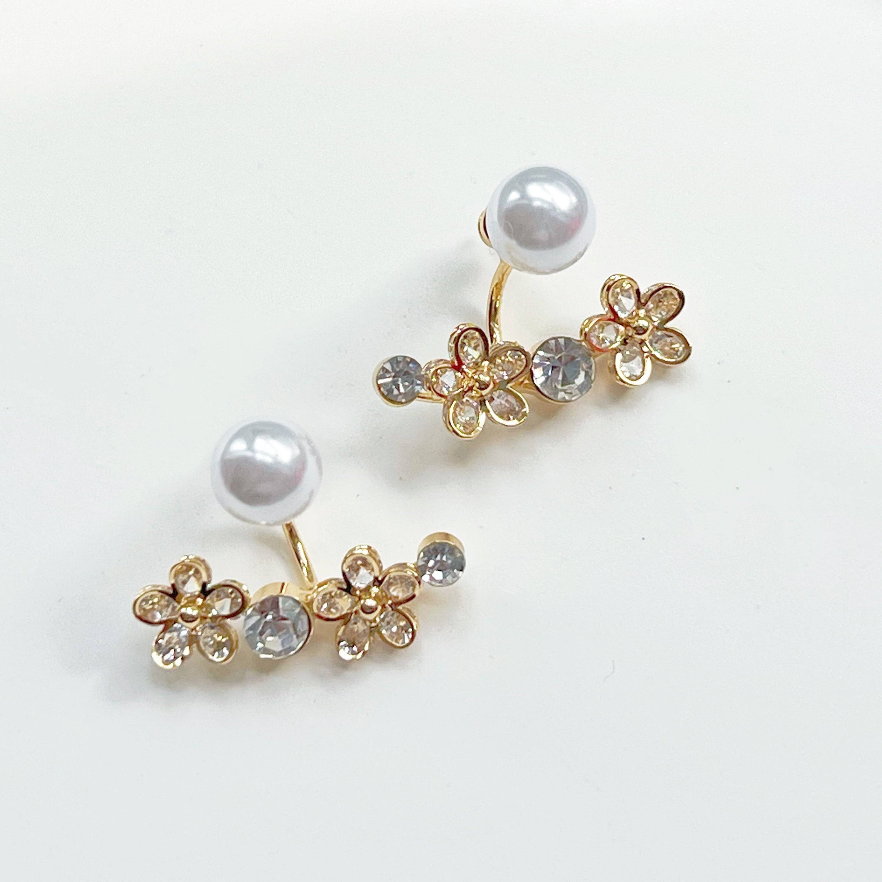 Elegant crystal flower and pearl ear jackets displayed in a gift box, showcasing their versatile design and quality materials.