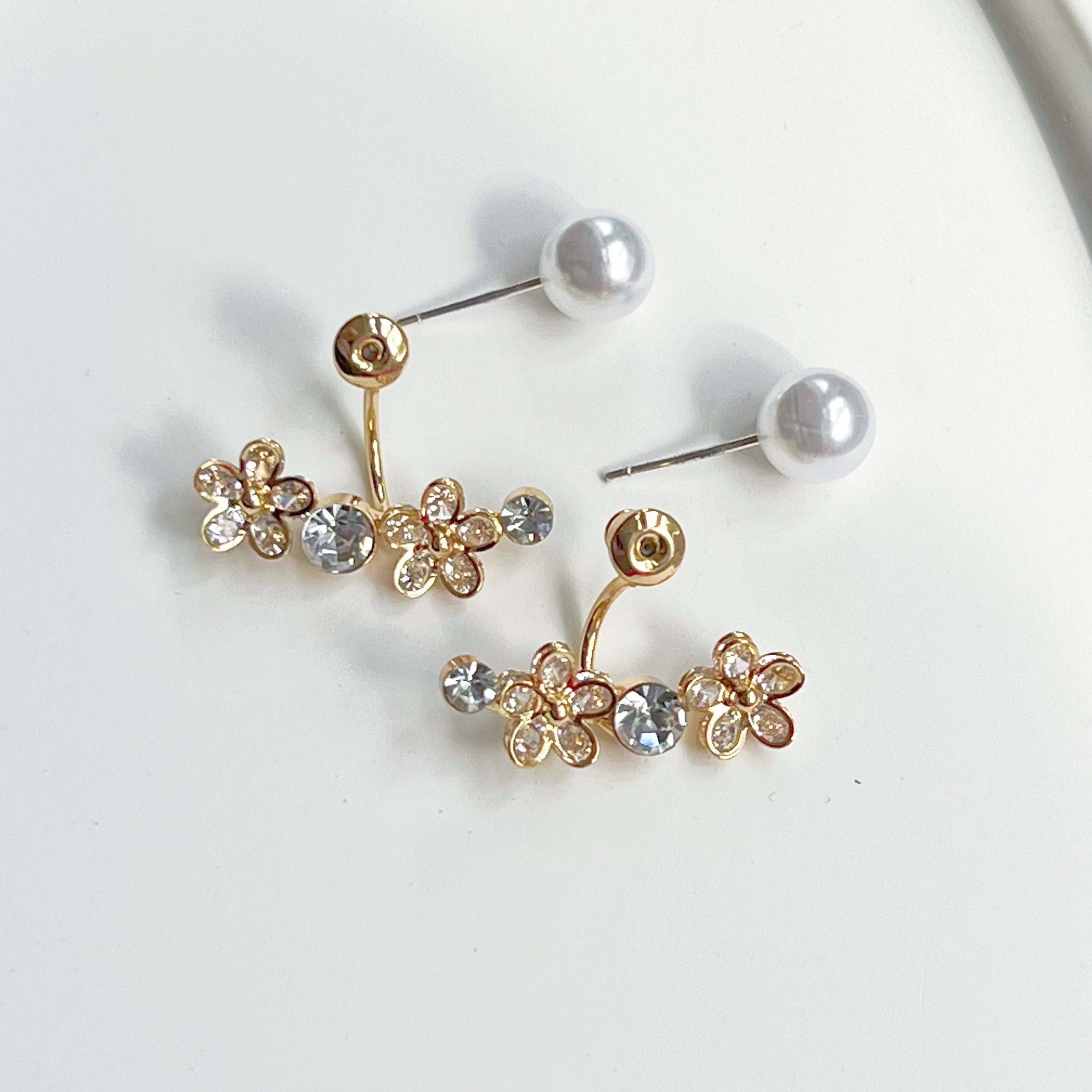 Elegant crystal flower and pearl ear jackets displayed in a gift box, showcasing their versatile design and quality materials.