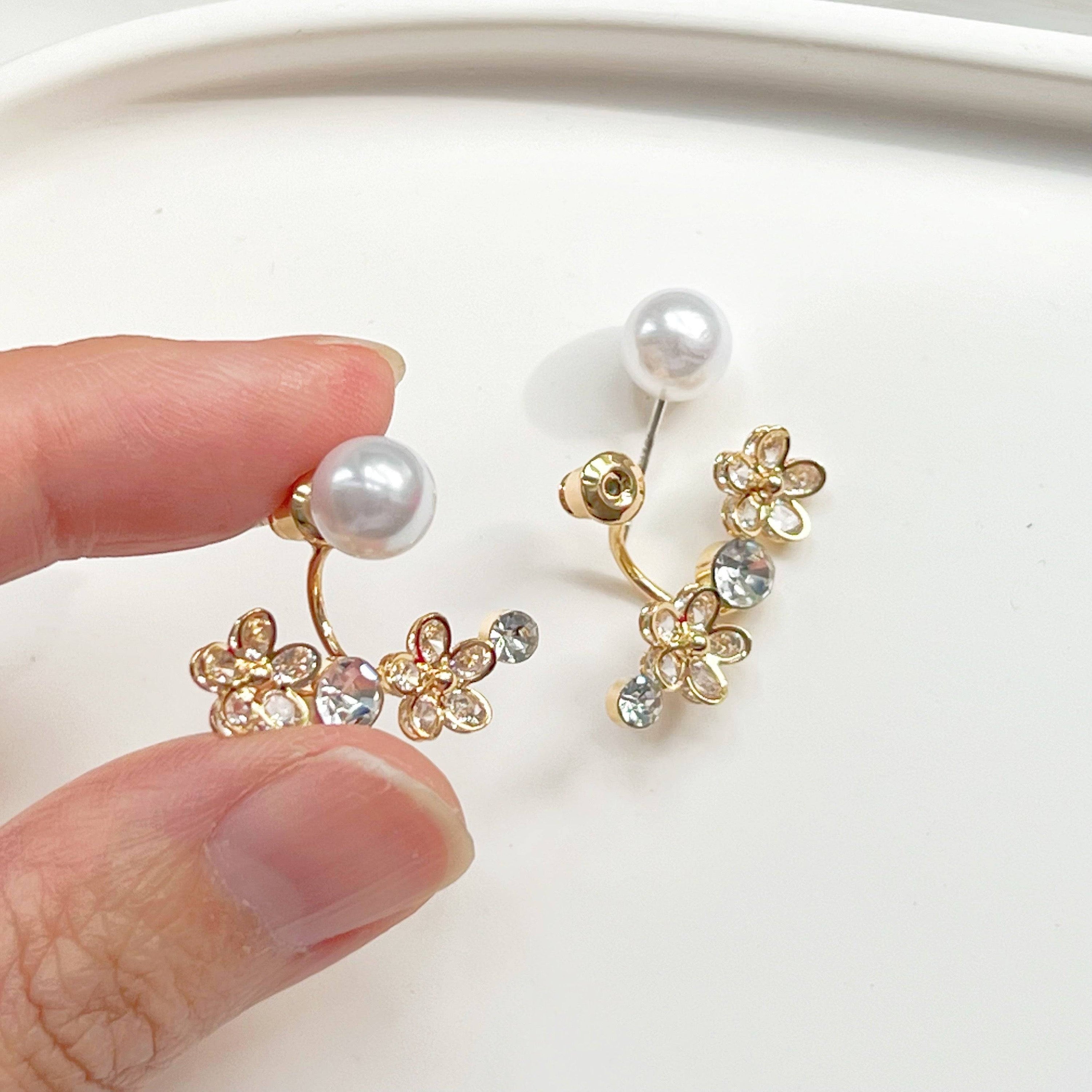 Elegant crystal flower and pearl ear jackets displayed in a gift box, showcasing their versatile design and quality materials.