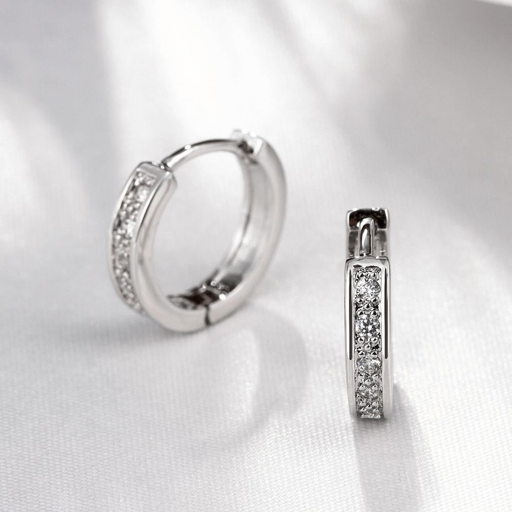 Elegant Crystal Huggie Earring in White Gold Plated, showcasing its shiny finish and comfortable design.