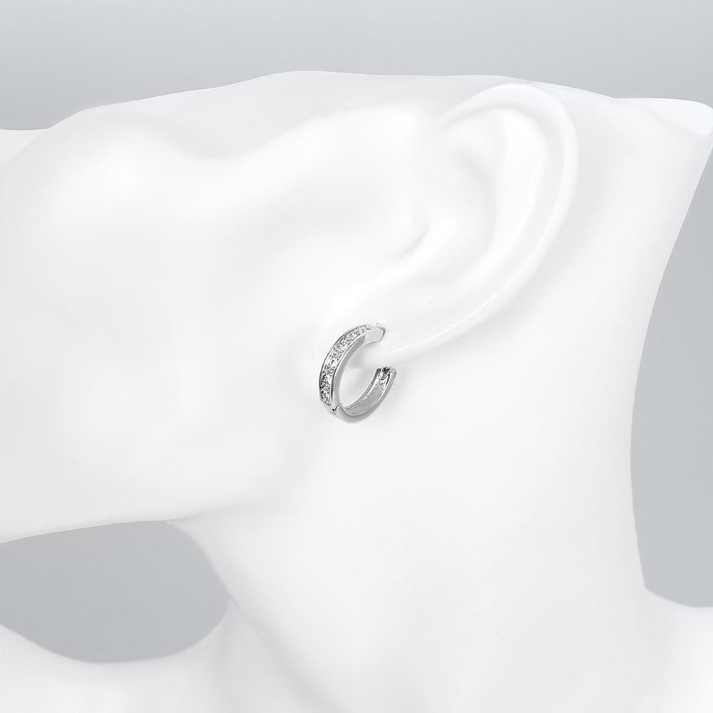 Elegant Crystal Huggie Earring in White Gold Plated, showcasing its shiny finish and comfortable design.