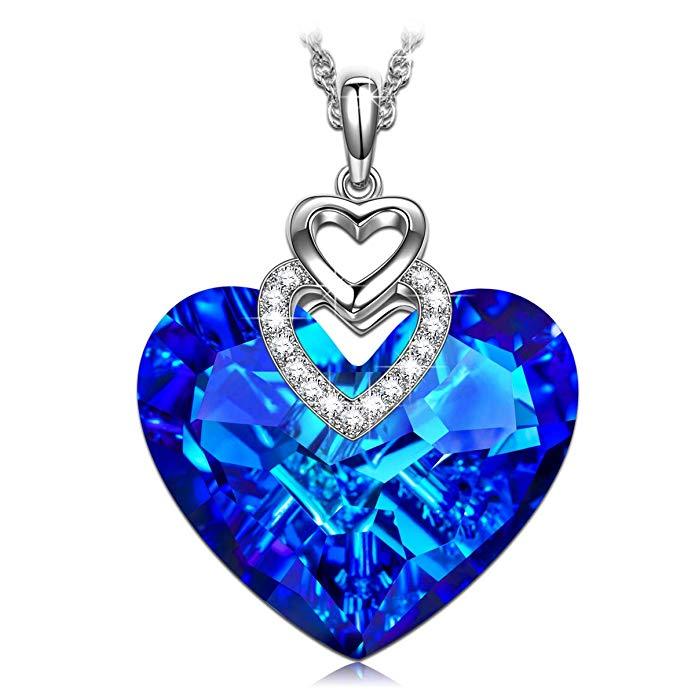 Crystals Bermuda Blue Pave Heart Drop Necklace featuring a heart-shaped pendant with sparkling blue crystals on a gold-plated chain.