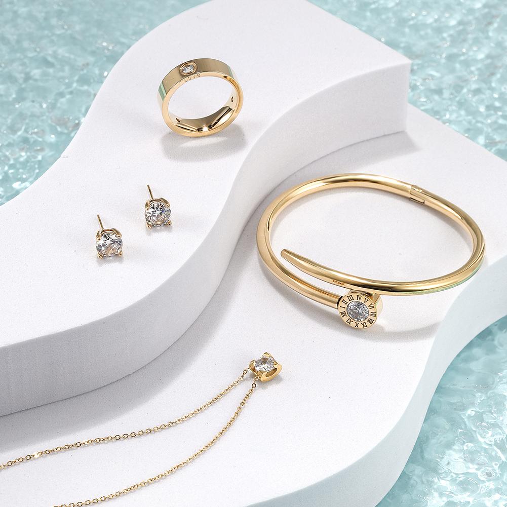 Cubic Zirconia Set featuring a necklace, bracelet, ring, and earrings, all crafted from stainless steel with sparkling cubic zirconia accents.