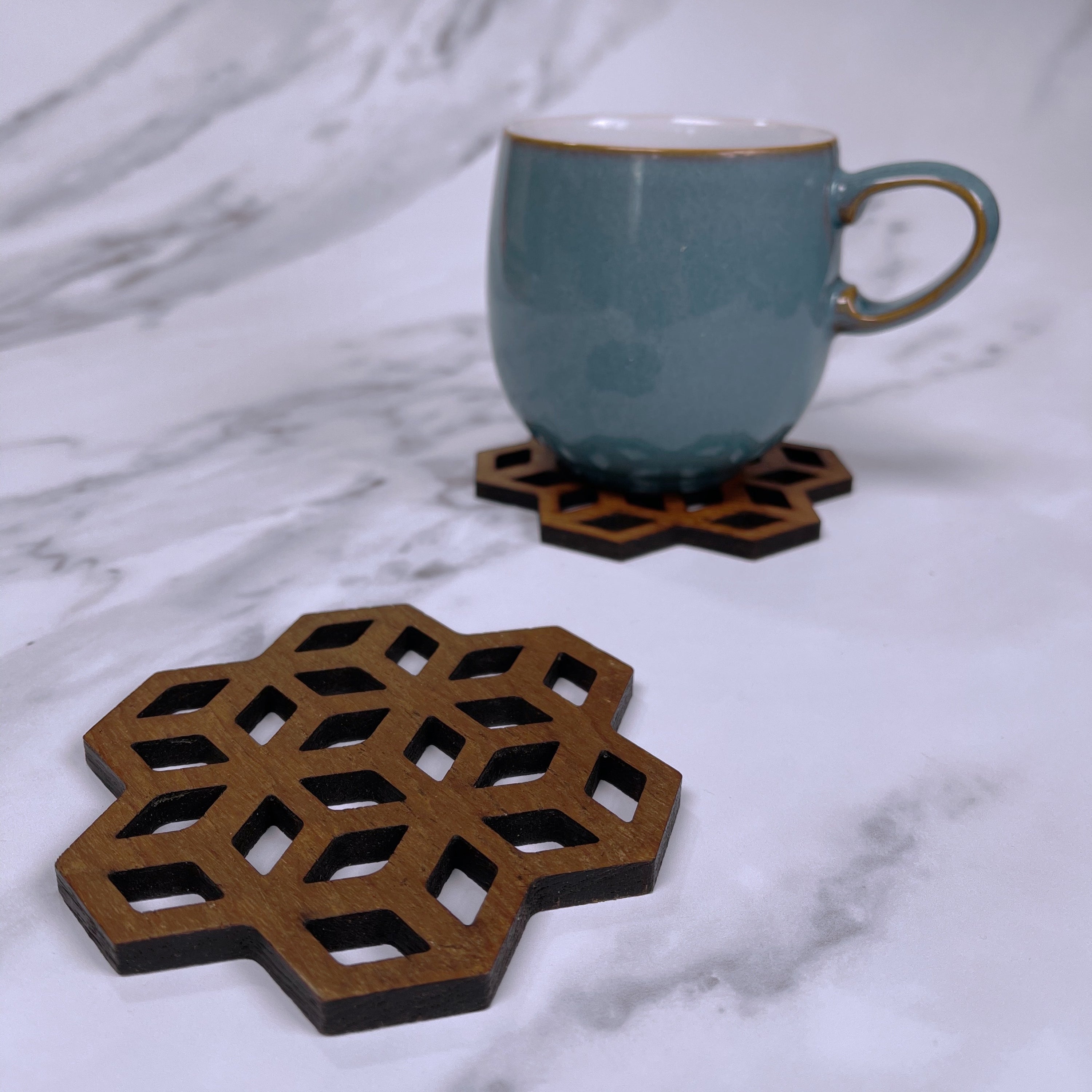 Set of Cubix Geometric Upcycled Teak Wood Coasters, showcasing unique geometric designs and natural wood grain.