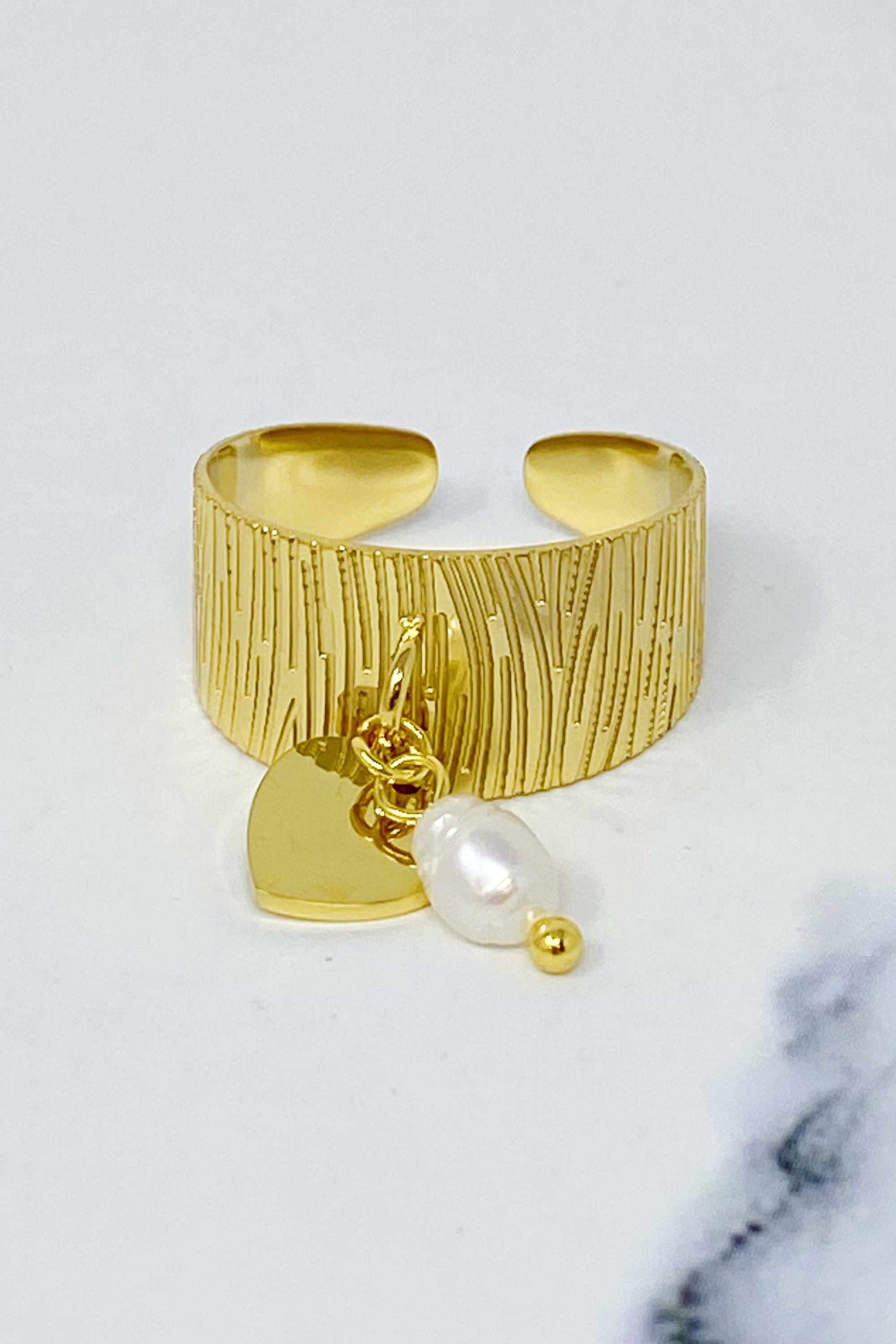 Cuff Dangle Ring featuring a dangle pearl and heart pendant, crafted from gold plated stainless steel.