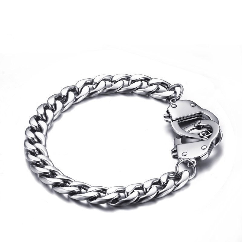 Curb handcuff bracelet made of stainless steel, featuring a sleek curb chain design and adjustable length.