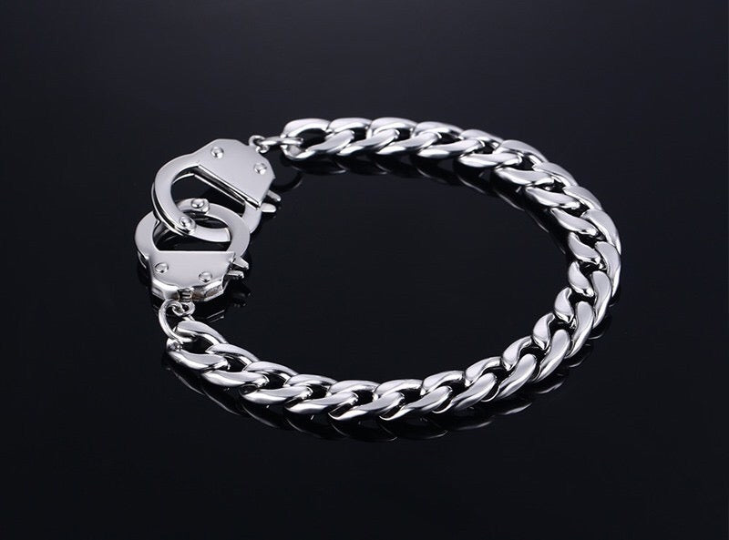 Curb handcuff bracelet made of stainless steel, featuring a sleek curb chain design and adjustable length.