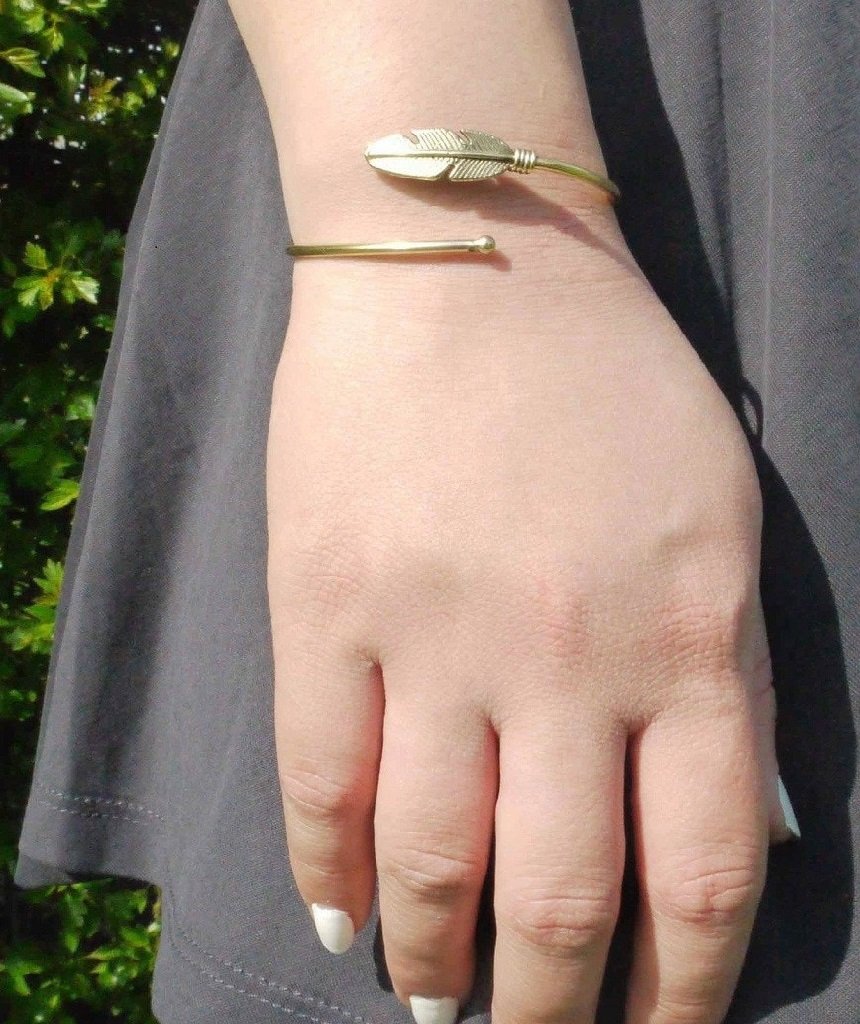 Curl Up Feather Bangle Bracelet in Gold and Silver with intricate feather design and semi-precious stone accents.