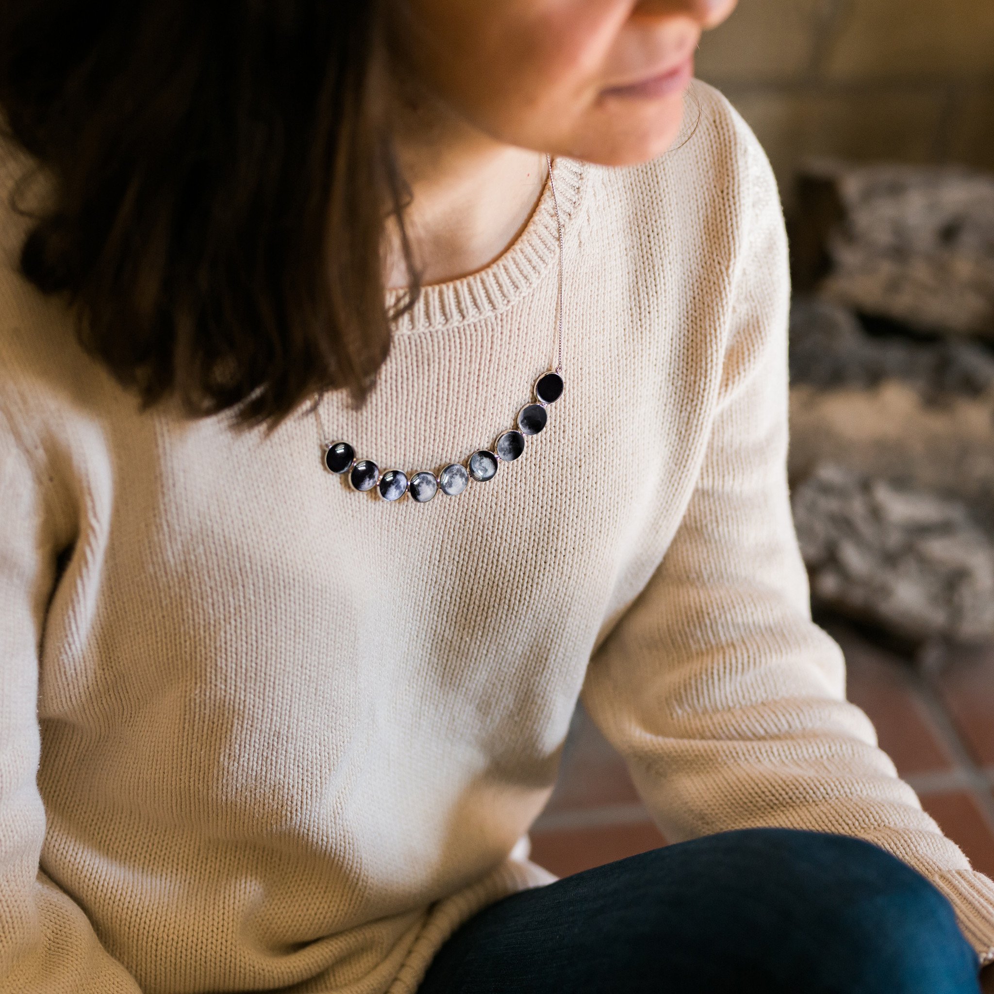 Curved Moon Phase Necklace in Silver showcasing nine lunar phases in handcrafted bezels, perfect for stargazers and moon lovers.