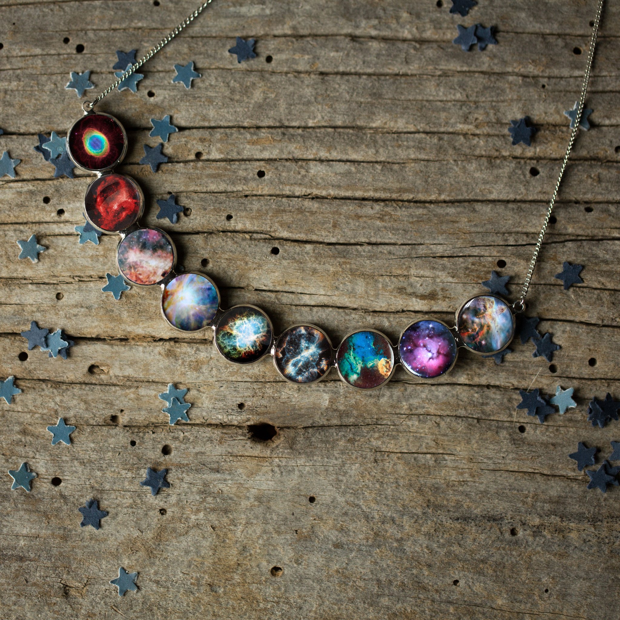 Curved Nebula Rainbow Necklace in Silver featuring nine colorful nebulae designs in silver bezels, perfect for stargazers.