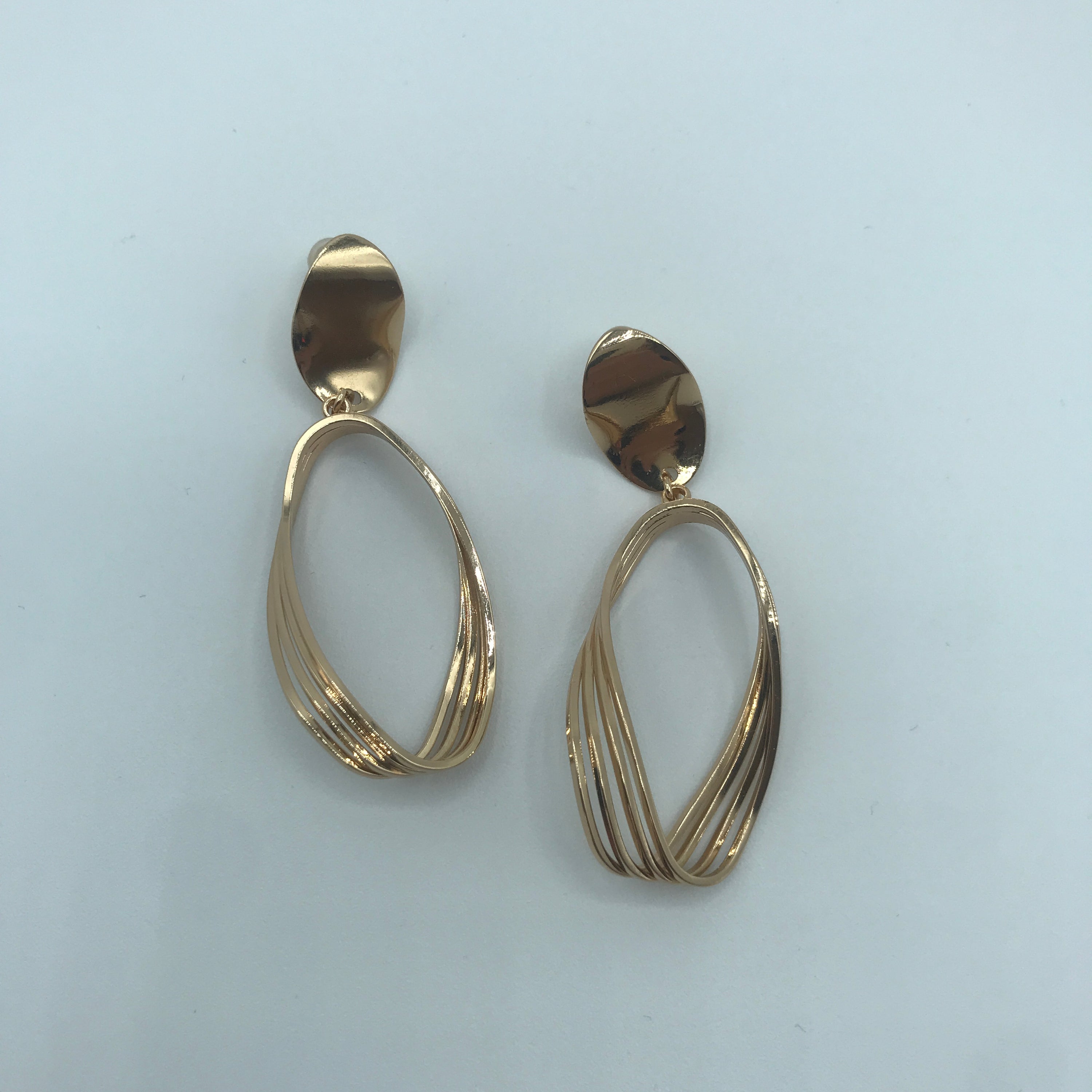 Elegant Curved Triple-lines Oval Earrings made of alloy, showcasing a modern design with a shiny finish.