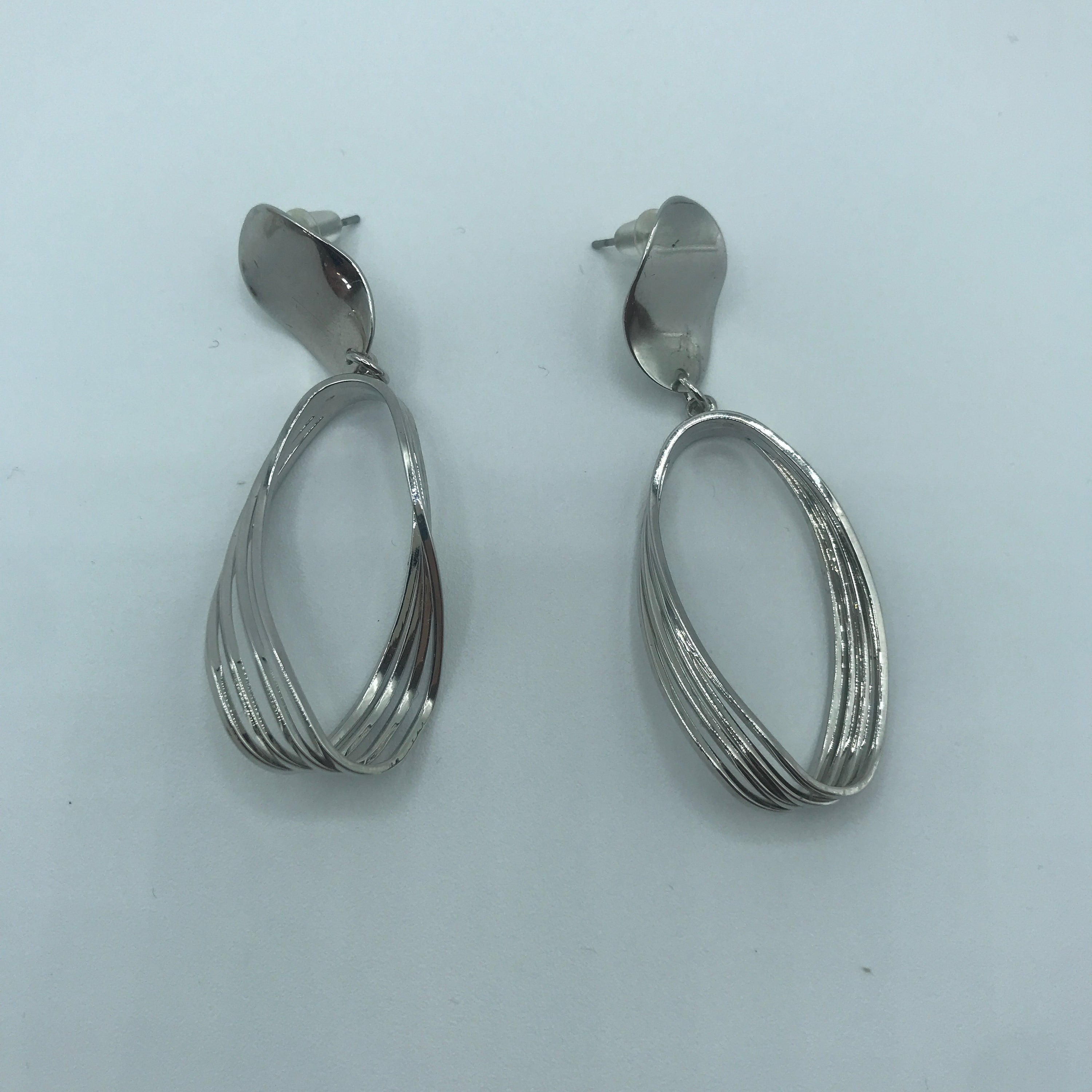 Elegant Curved Triple-lines Oval Earrings made of alloy, showcasing a modern design with a shiny finish.