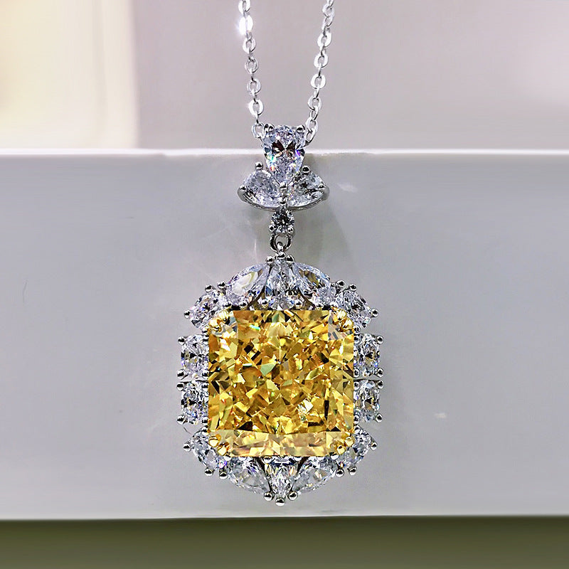 A stunning cushion cut fancy yellow citrine necklace set in 925 sterling silver with white gold accents, featuring brilliant white sapphires.